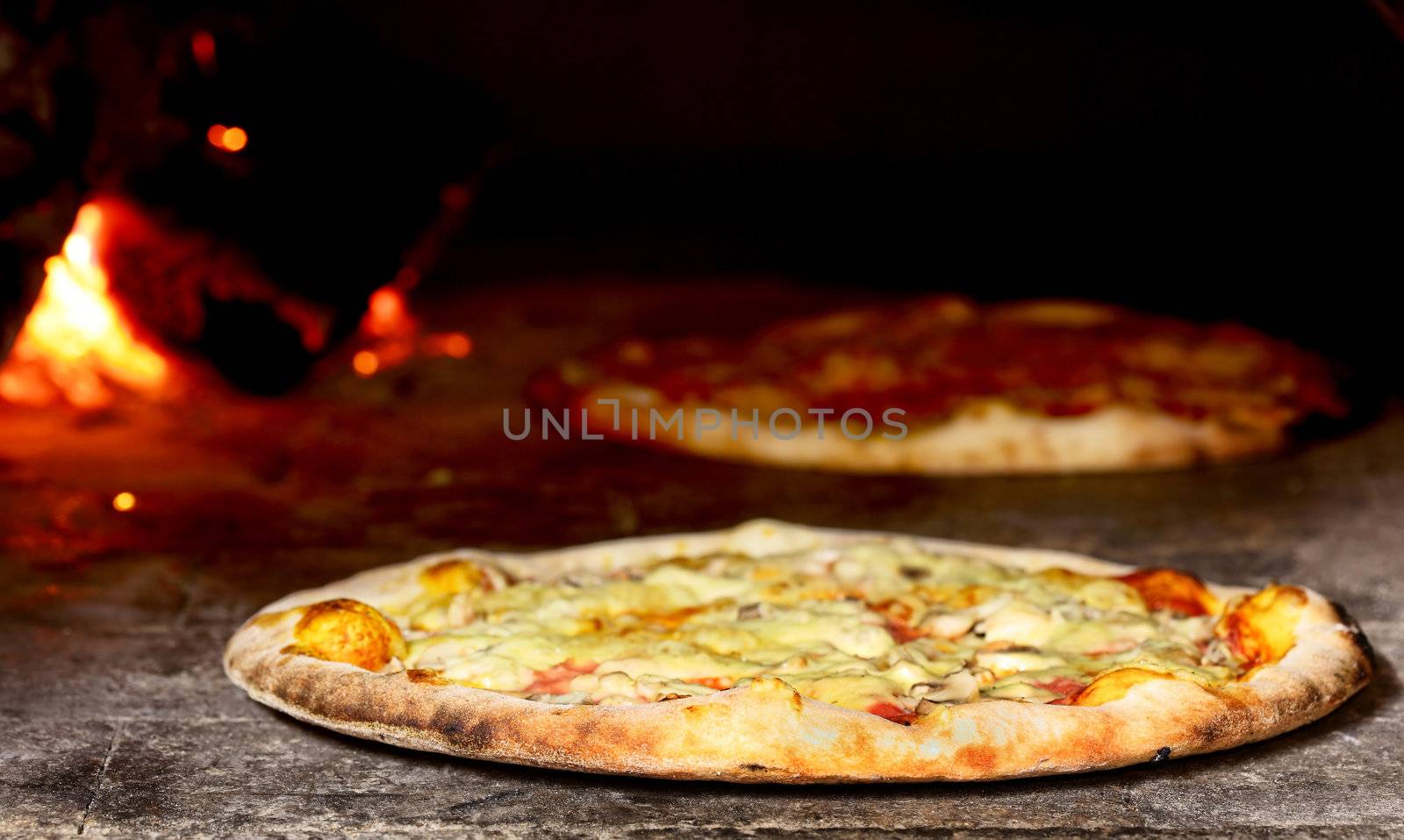 delicious pizza baking in wood fired oven