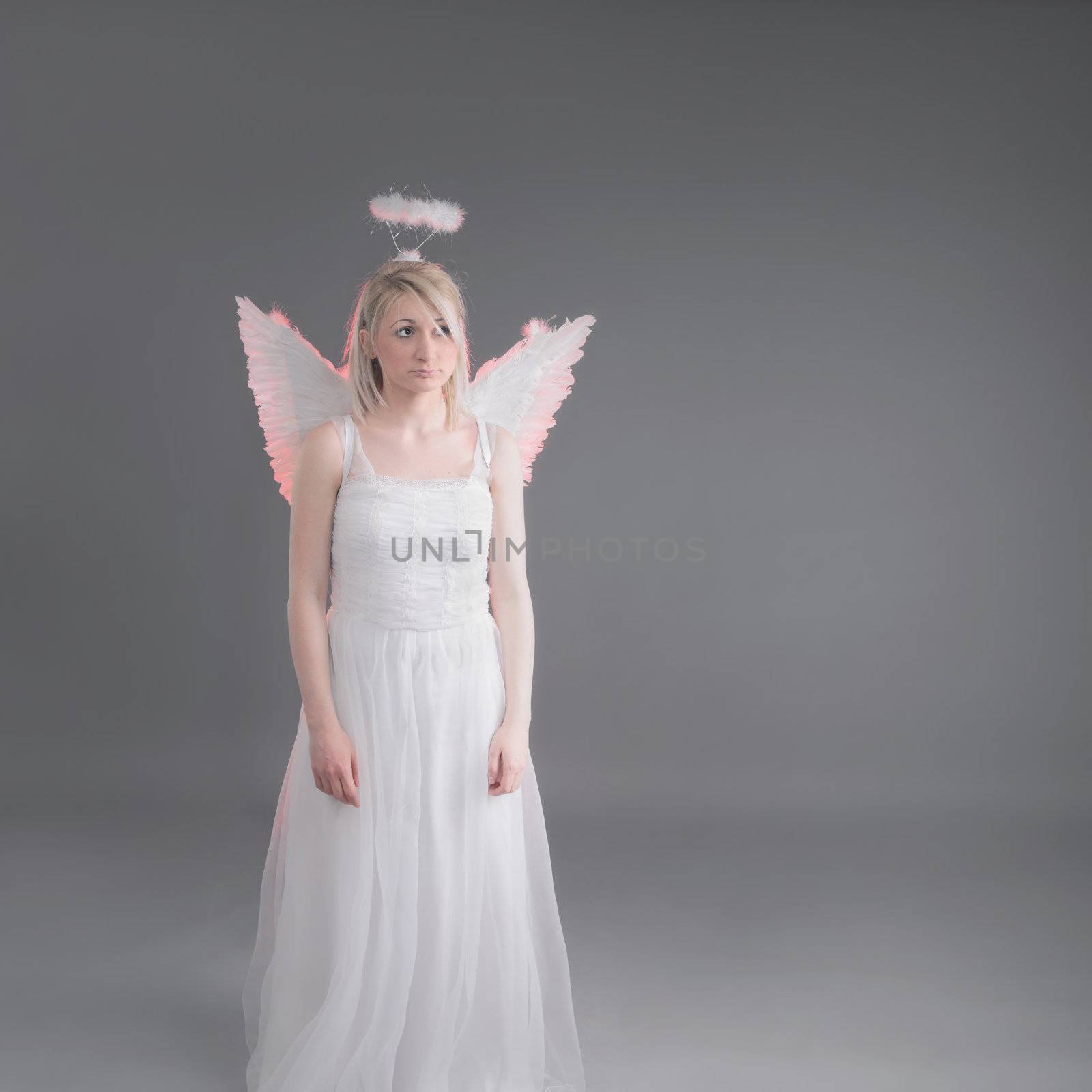 sad female angel in white outfit with wings and aureola