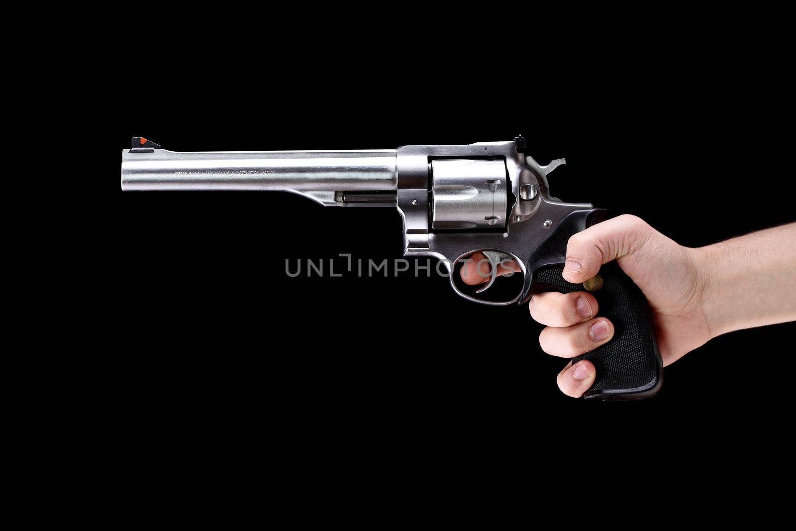 hand holding a revolver, aiming straight, against black background