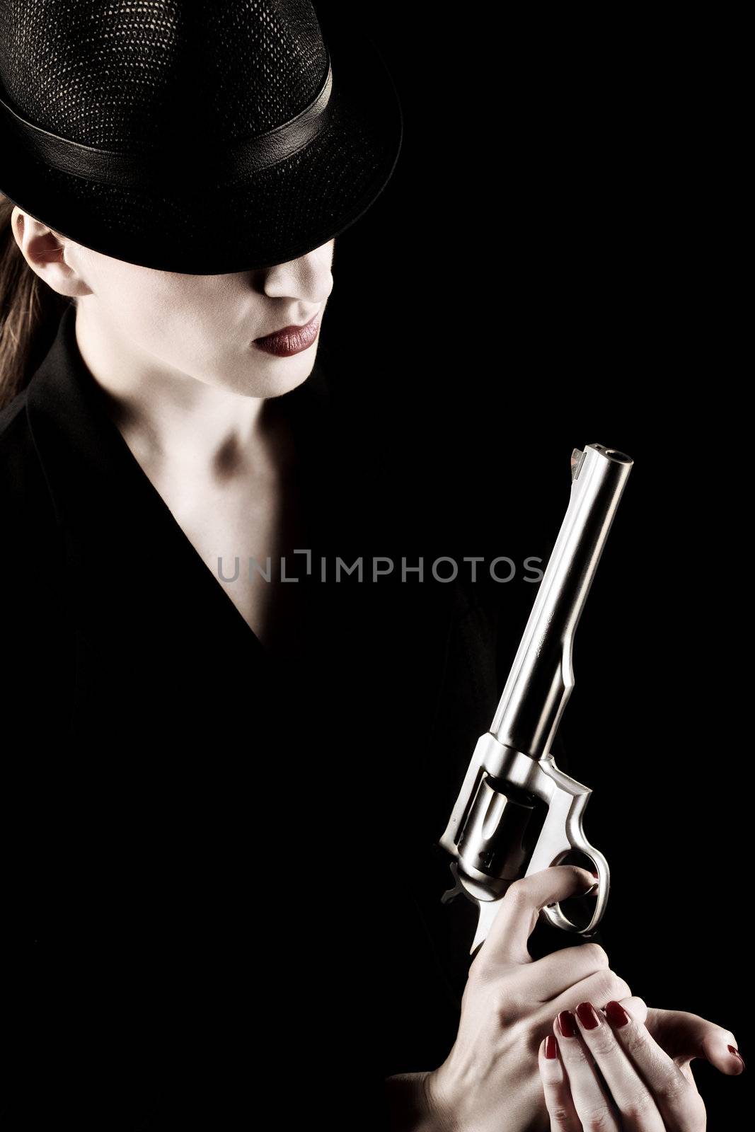 elegant lady in black holding a revolver