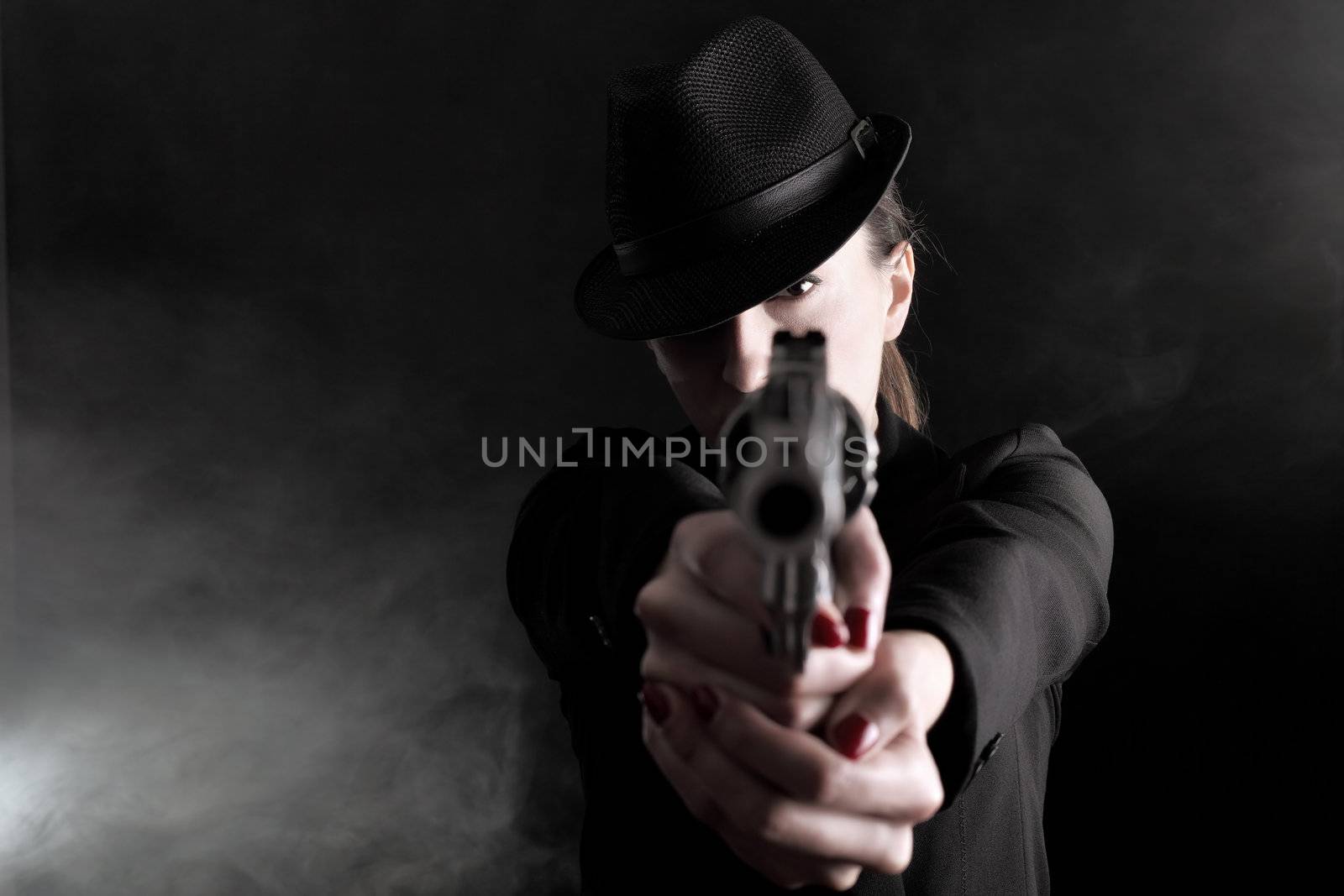 elegant lady in black holding a revolver