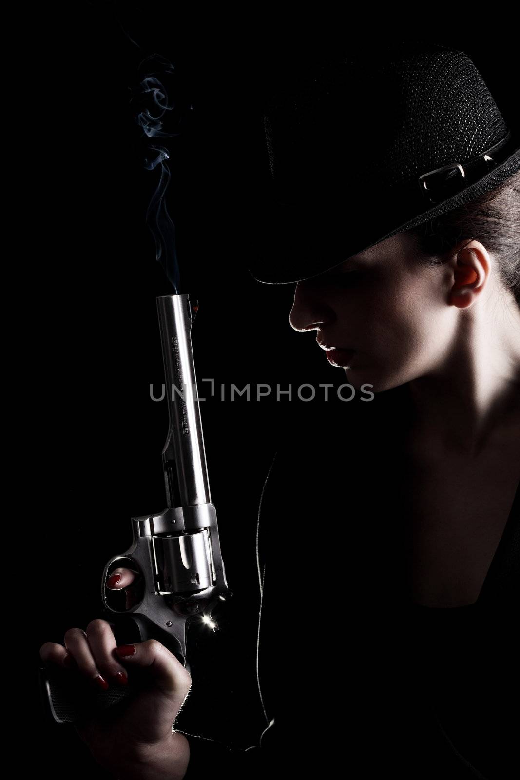 elegant lady in black holding a revolver