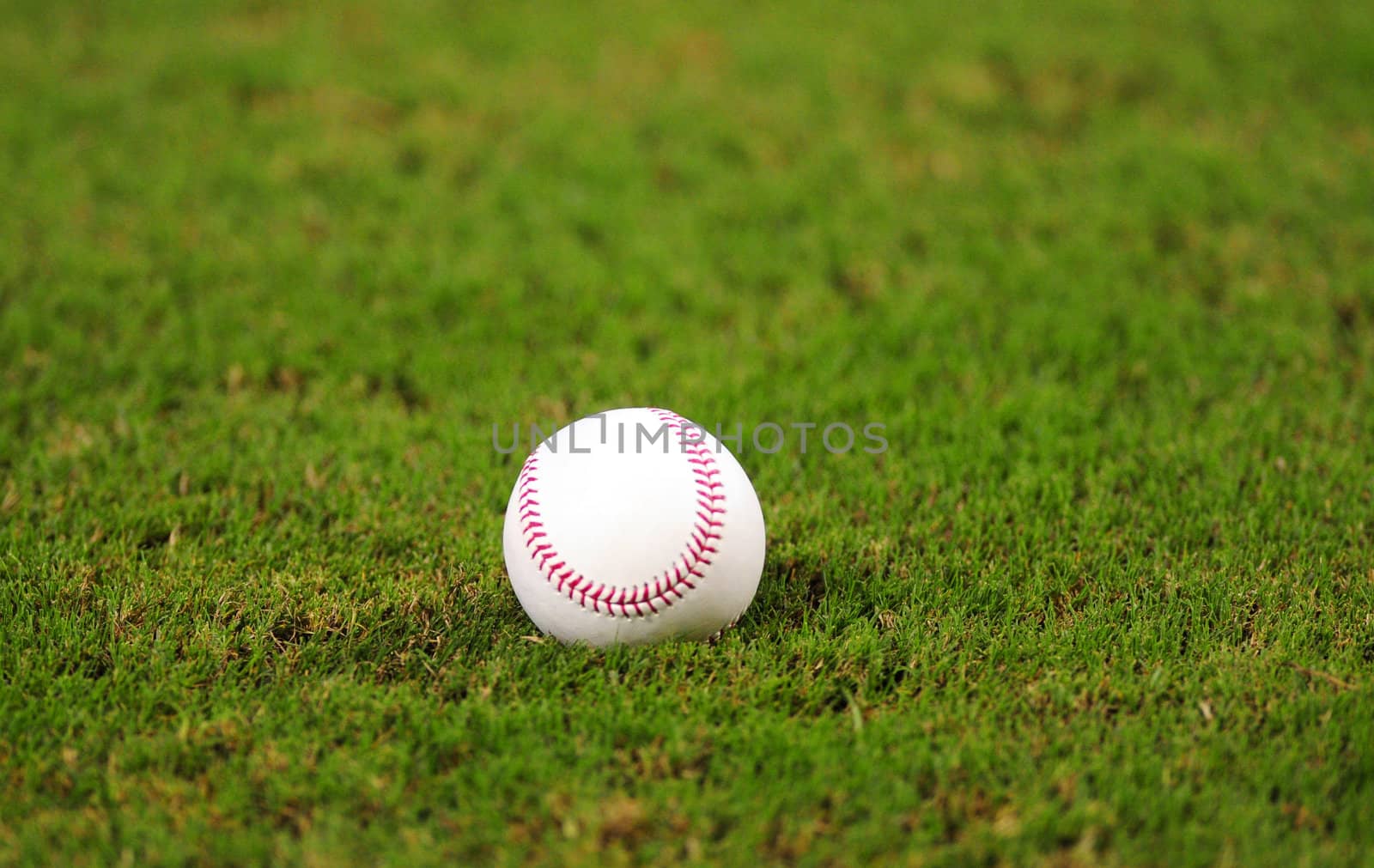 one baseball on grass in baseball field