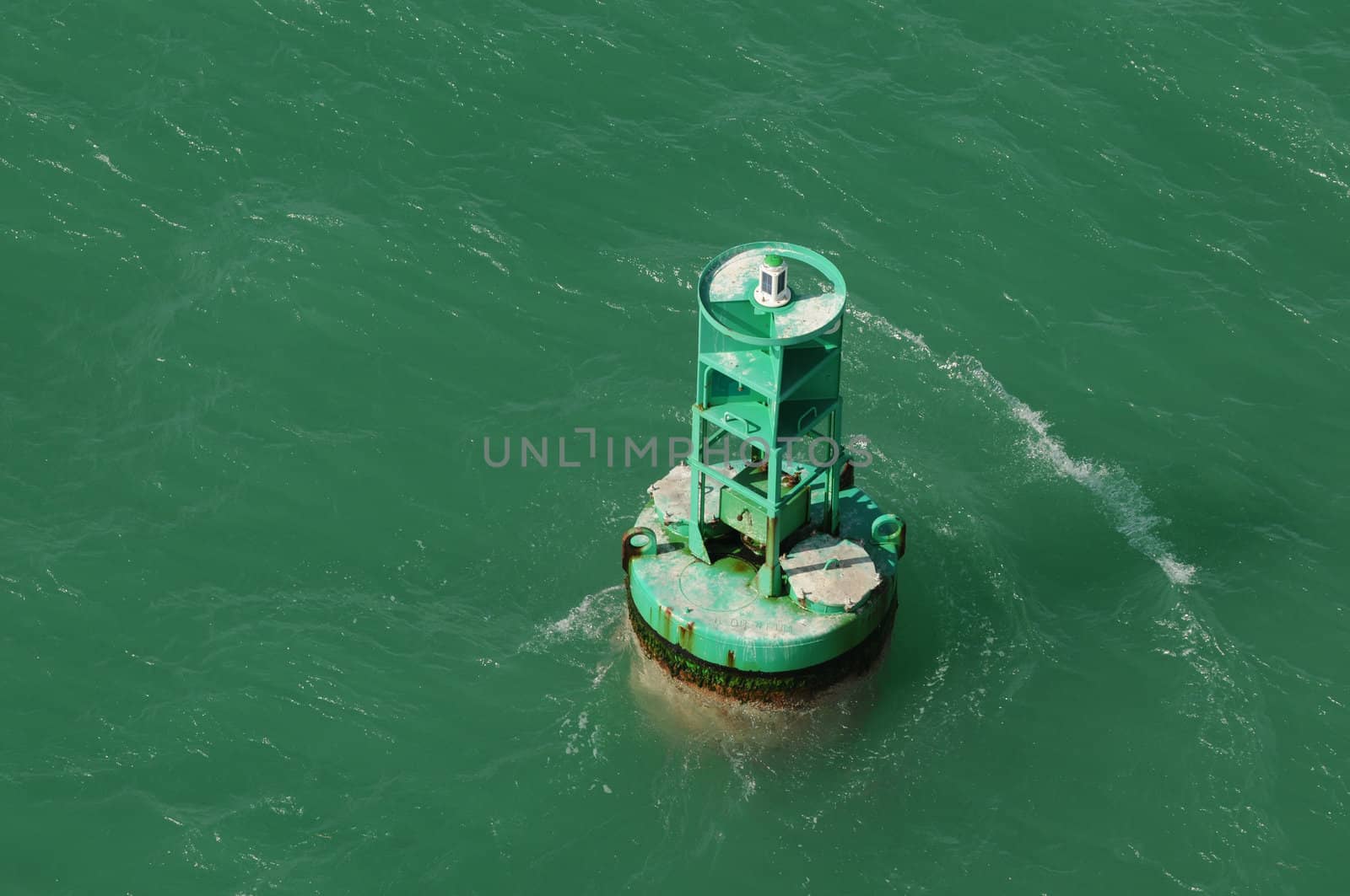 green buoy in ocean water