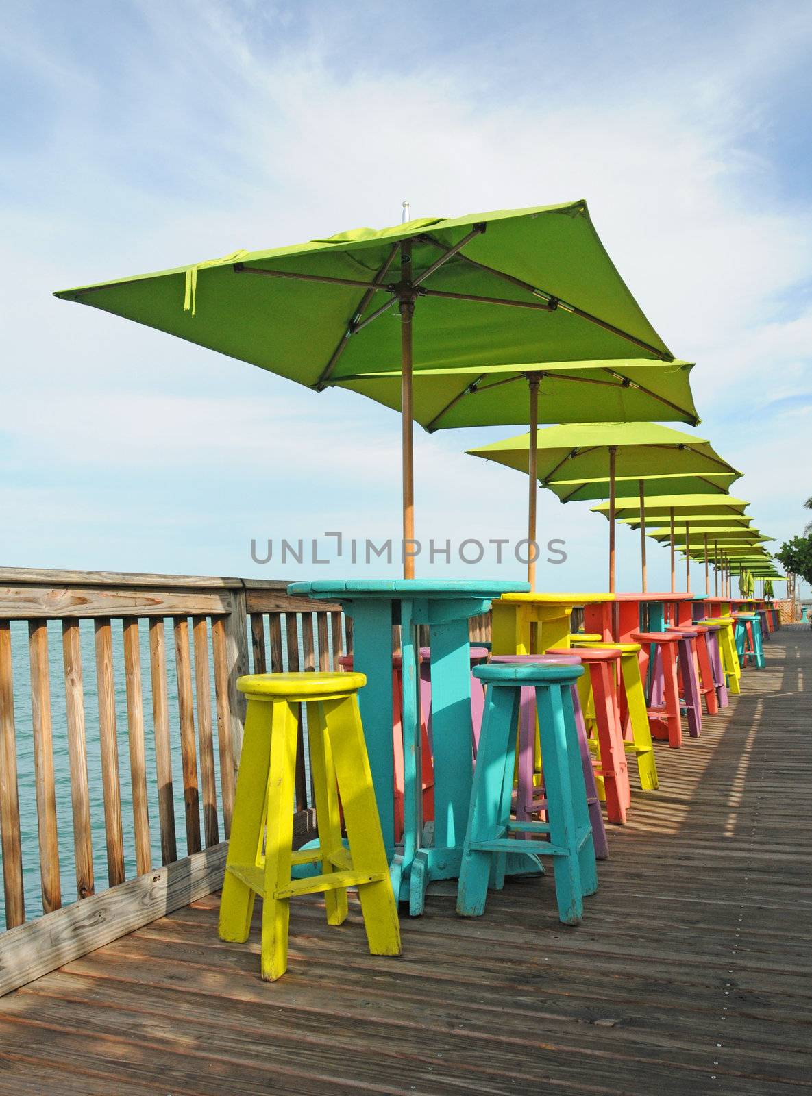 colorful tables and chairs overlooking ocean