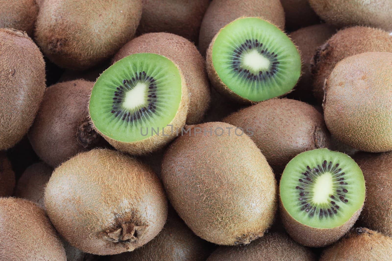 A few brown fresh kiwi fruits slices