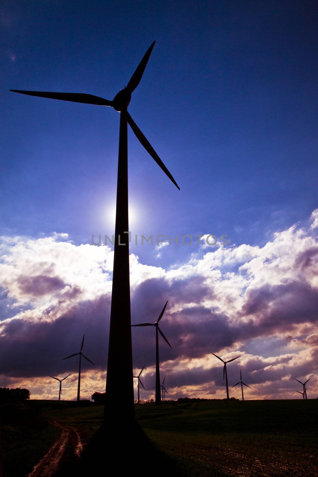 Windmills against a dark, cloudy sky, alternative energy source