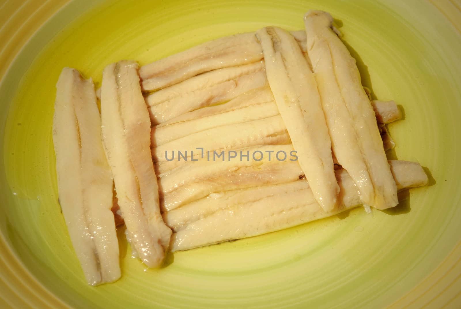 anchovies in a green dish, typical spanish cuisine