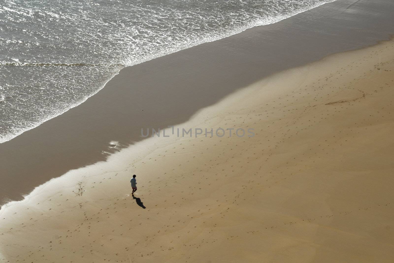 single man jogging on the beach by Carche