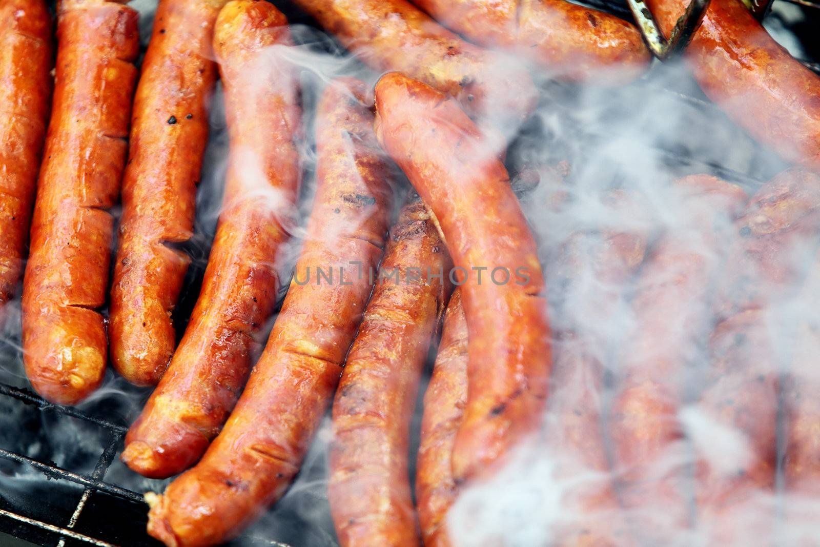 sausages being cooked on hot grill