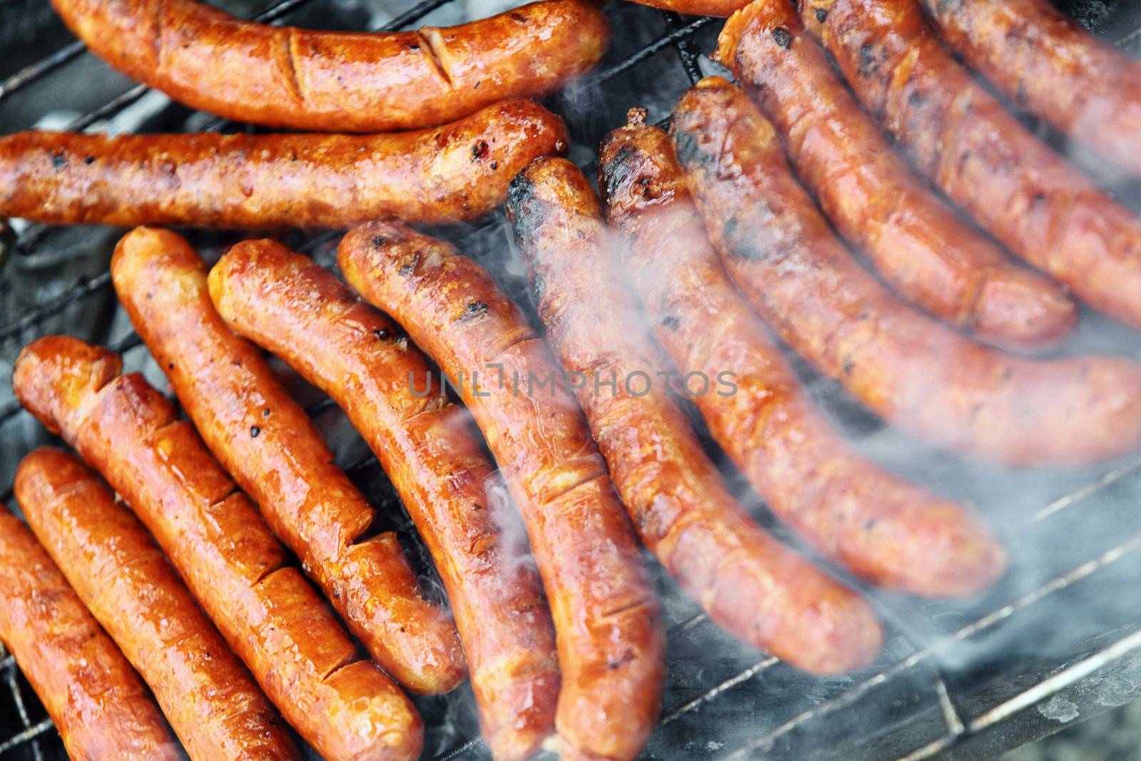 sausages being cooked on hot grill