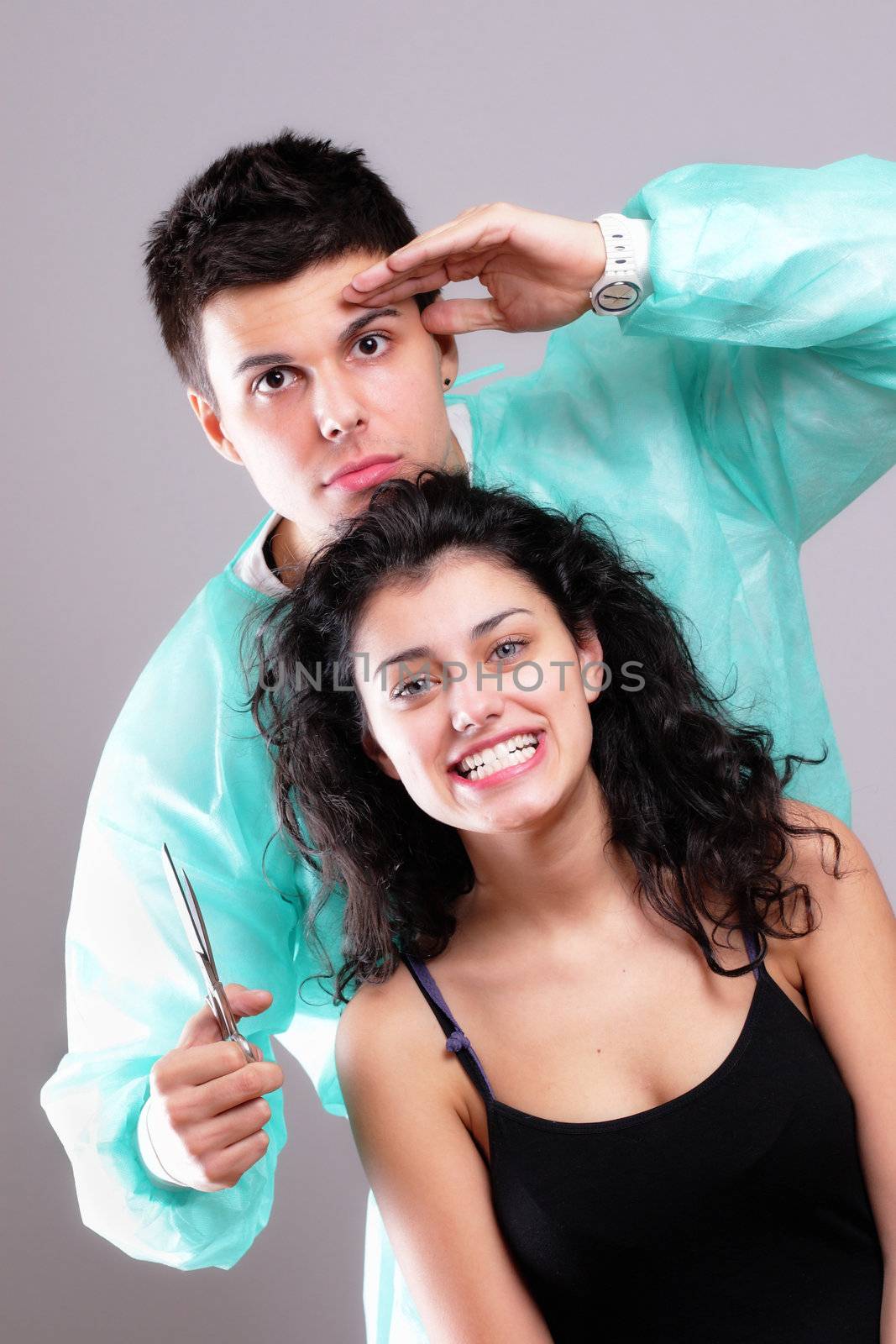 portrait of a barber cutting female hair