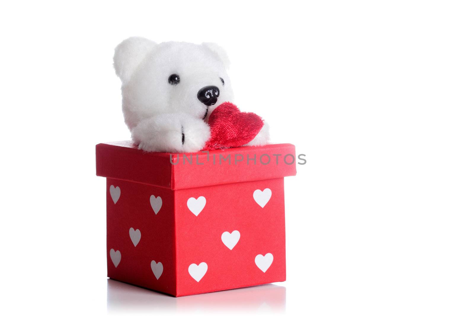 teddy bear with a heart on a red gift box