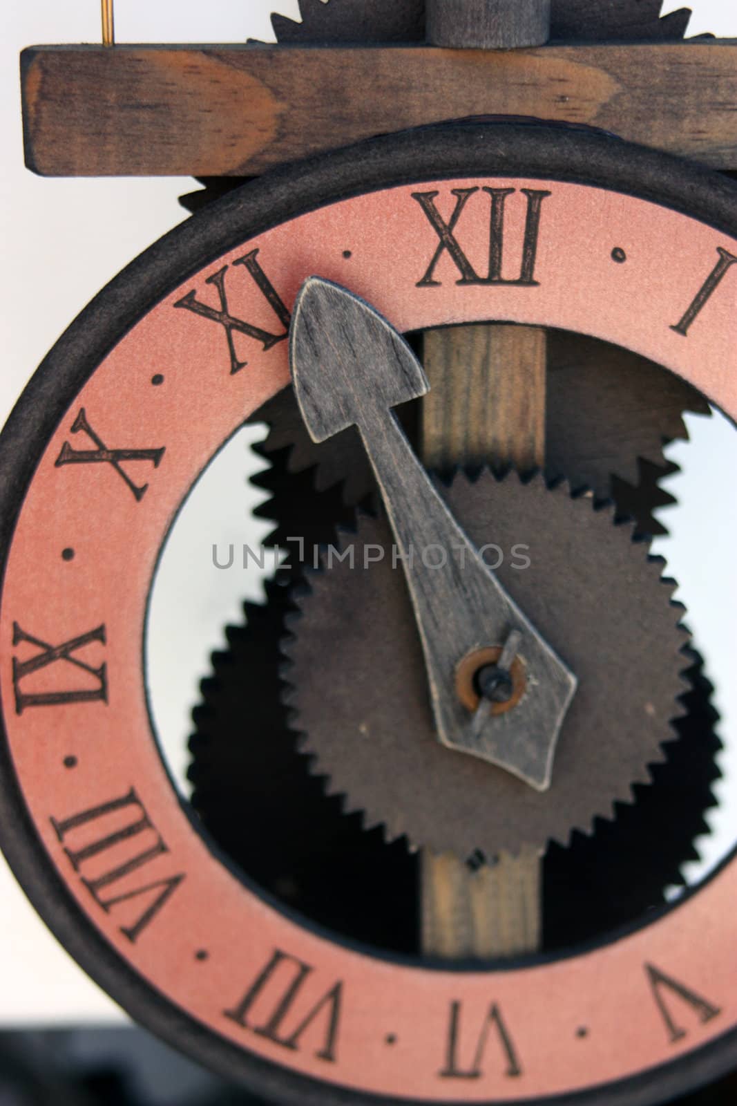 Imitation antique wall clock with arrows and numbers.