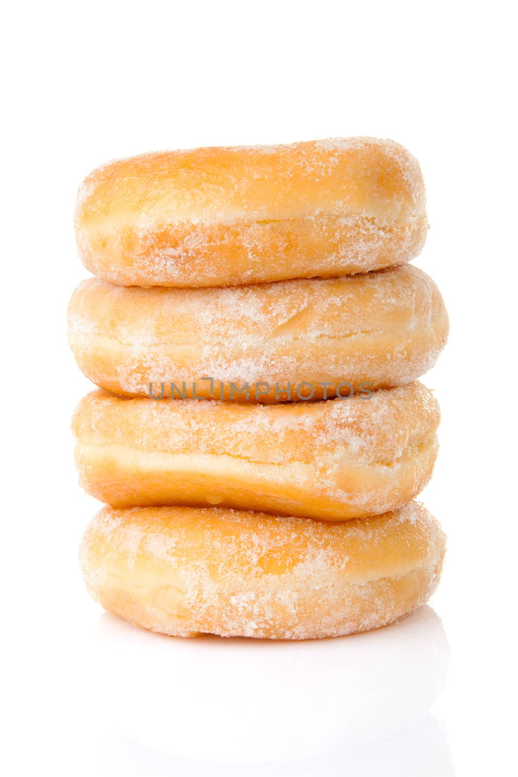 Stacked delicious sugared donuts over white background
