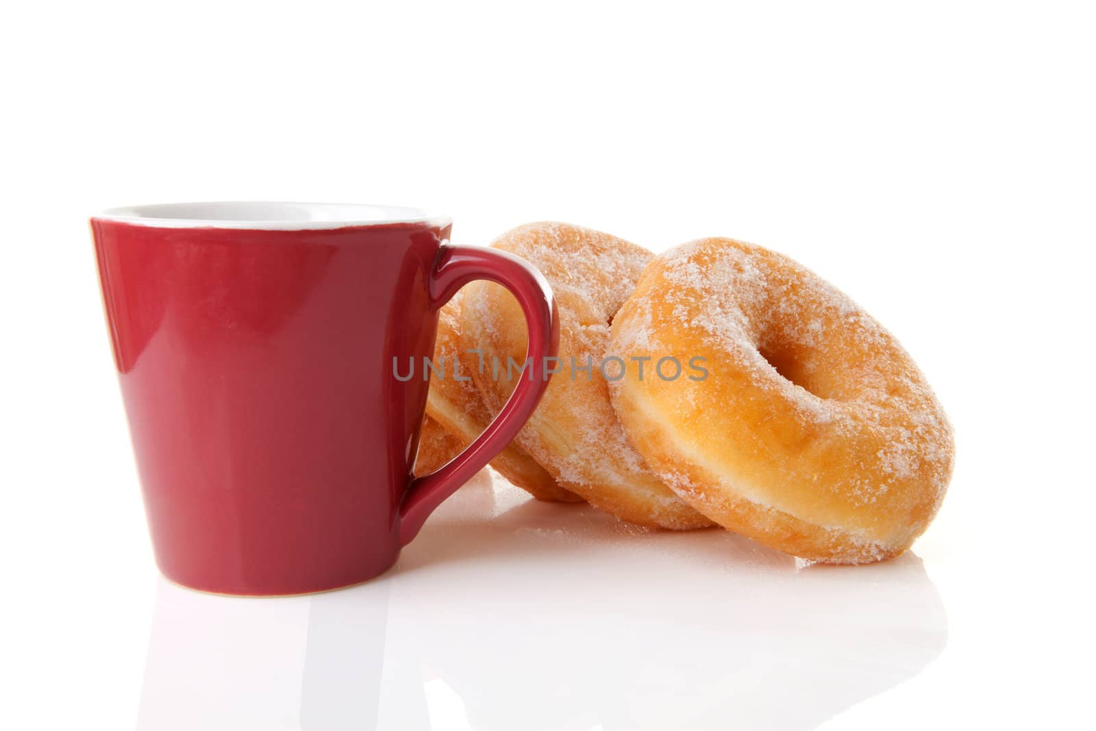 Cup of coffee and sugared donuts over white background