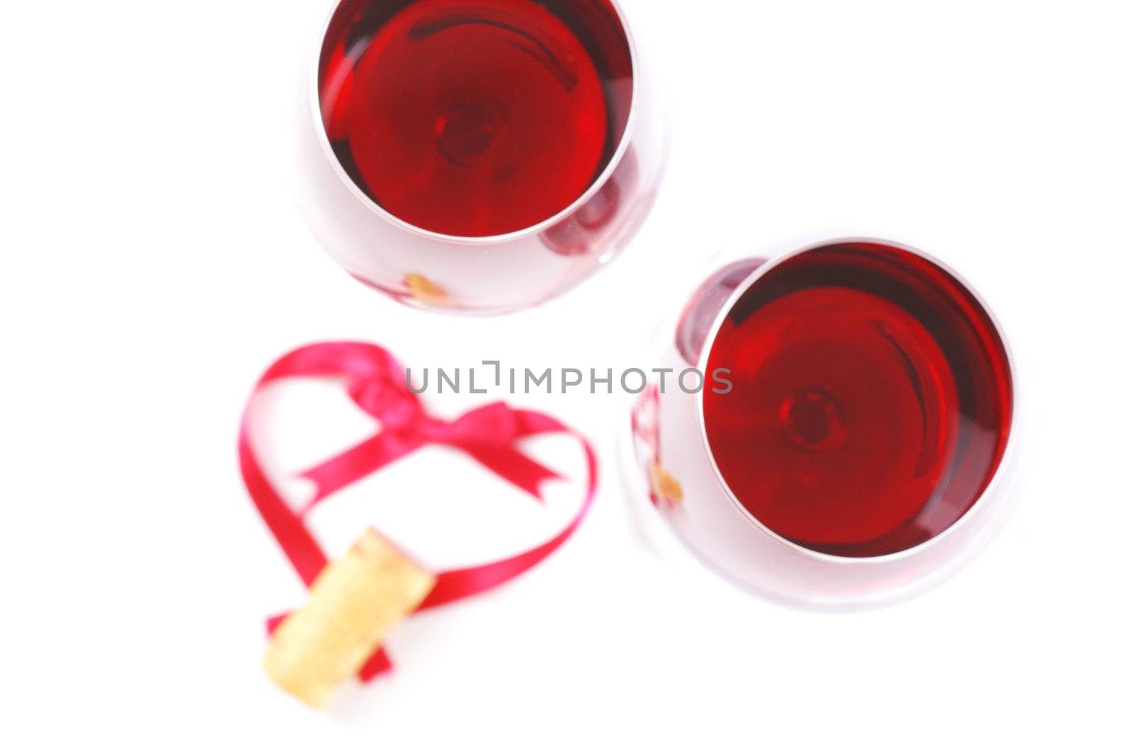 wine glasees with a cork and a ribbon heart