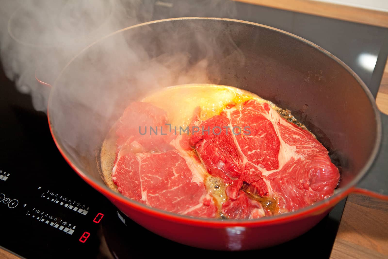 Closeup of baking beef in saucepan