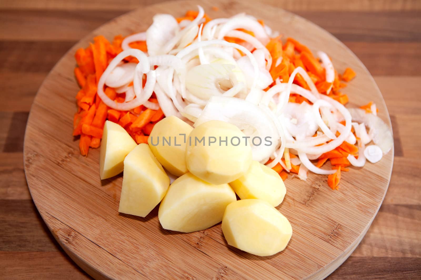 Ingredients for Dutch hutspot stew on wooden cutting board in closeup 