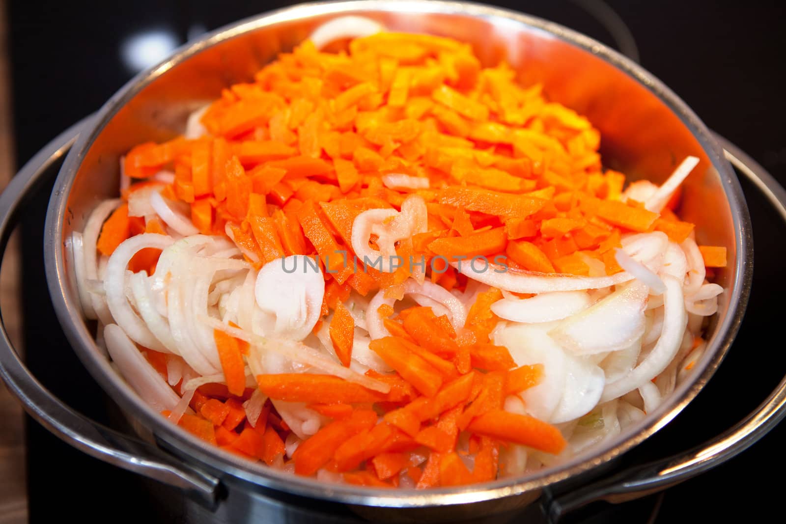 Closeup of Carrots and onions for Dutch hutspot stew in pan