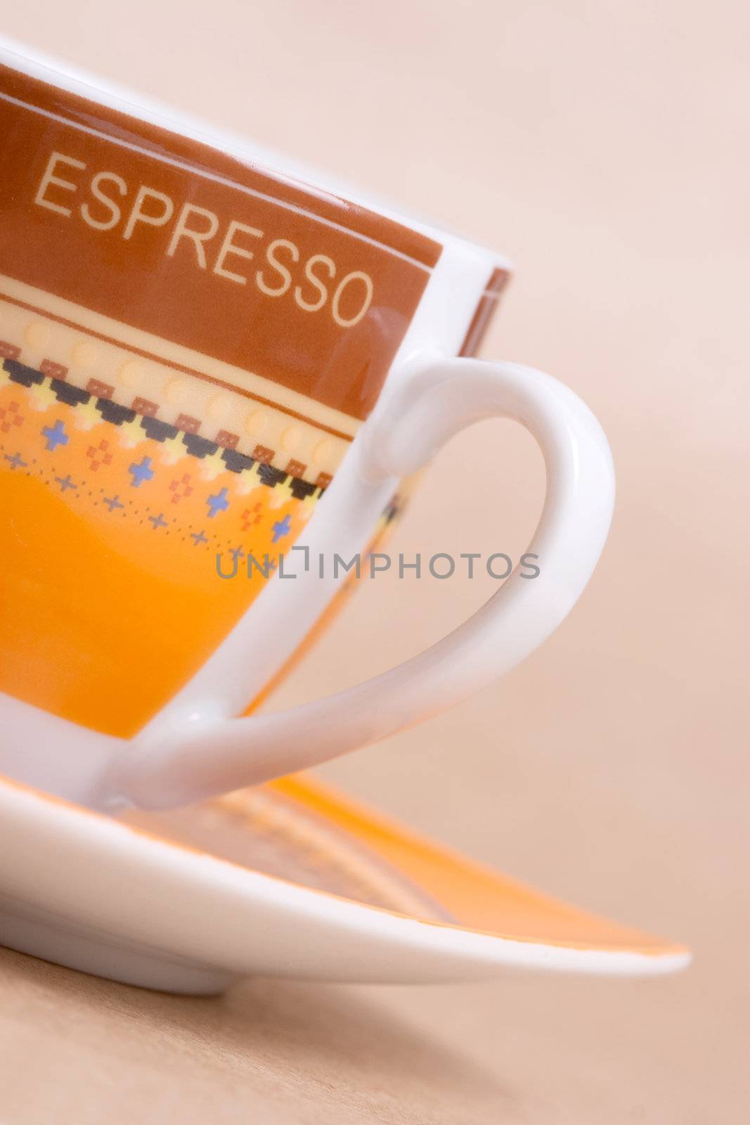 orange espresso cup on ochre background