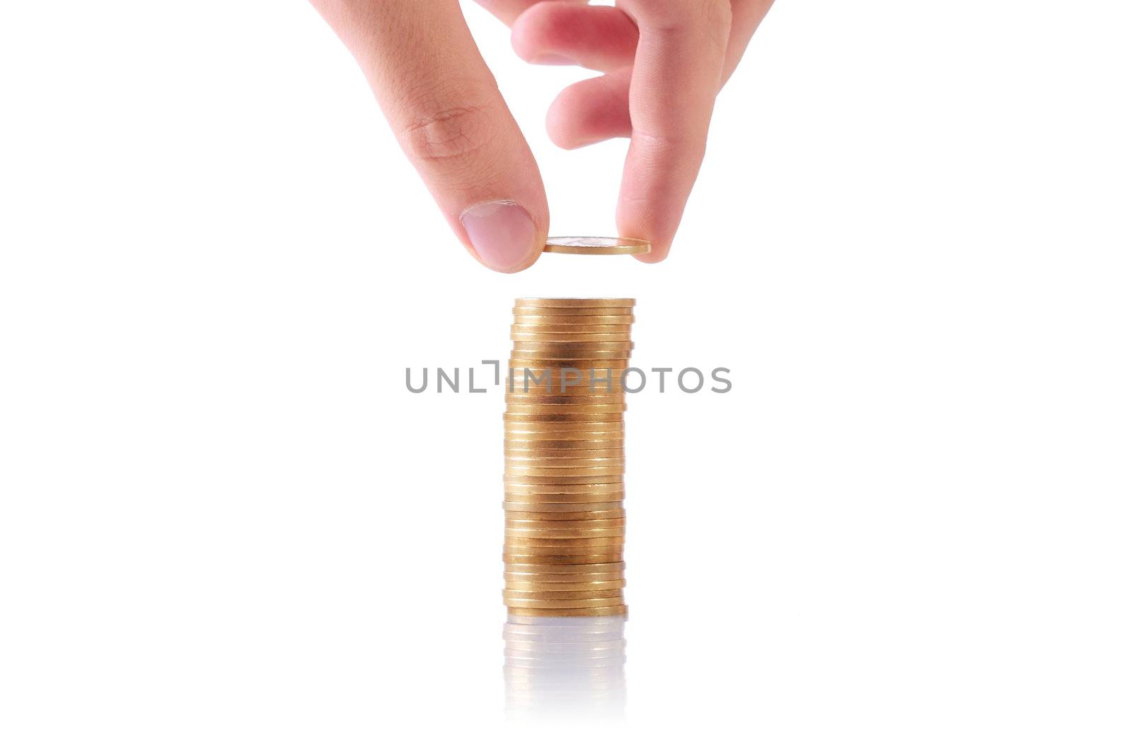 hand adding a coin to a stack of coins