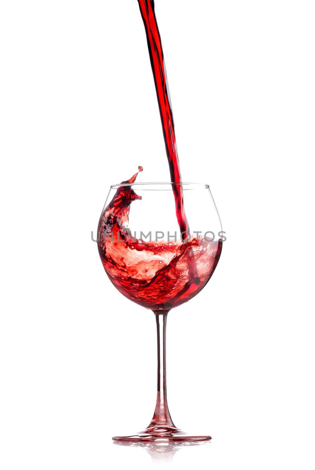 red wine splashing in a glass, isolated on white