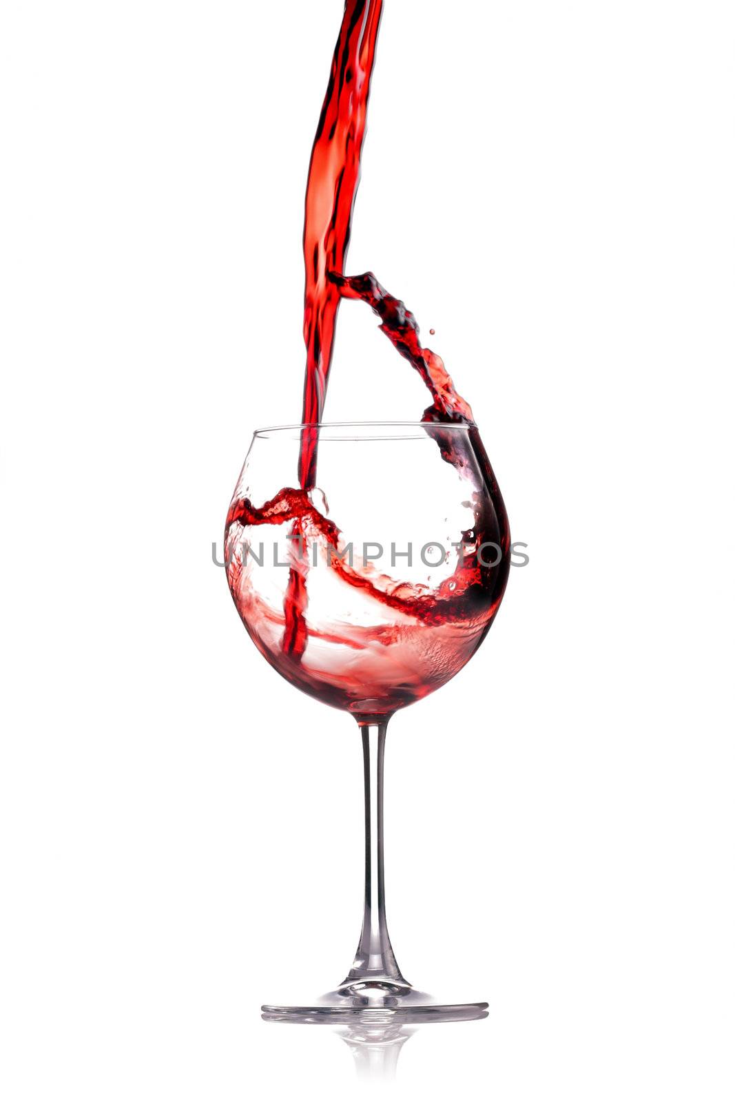 red wine splashing in a glass, isolated on white
