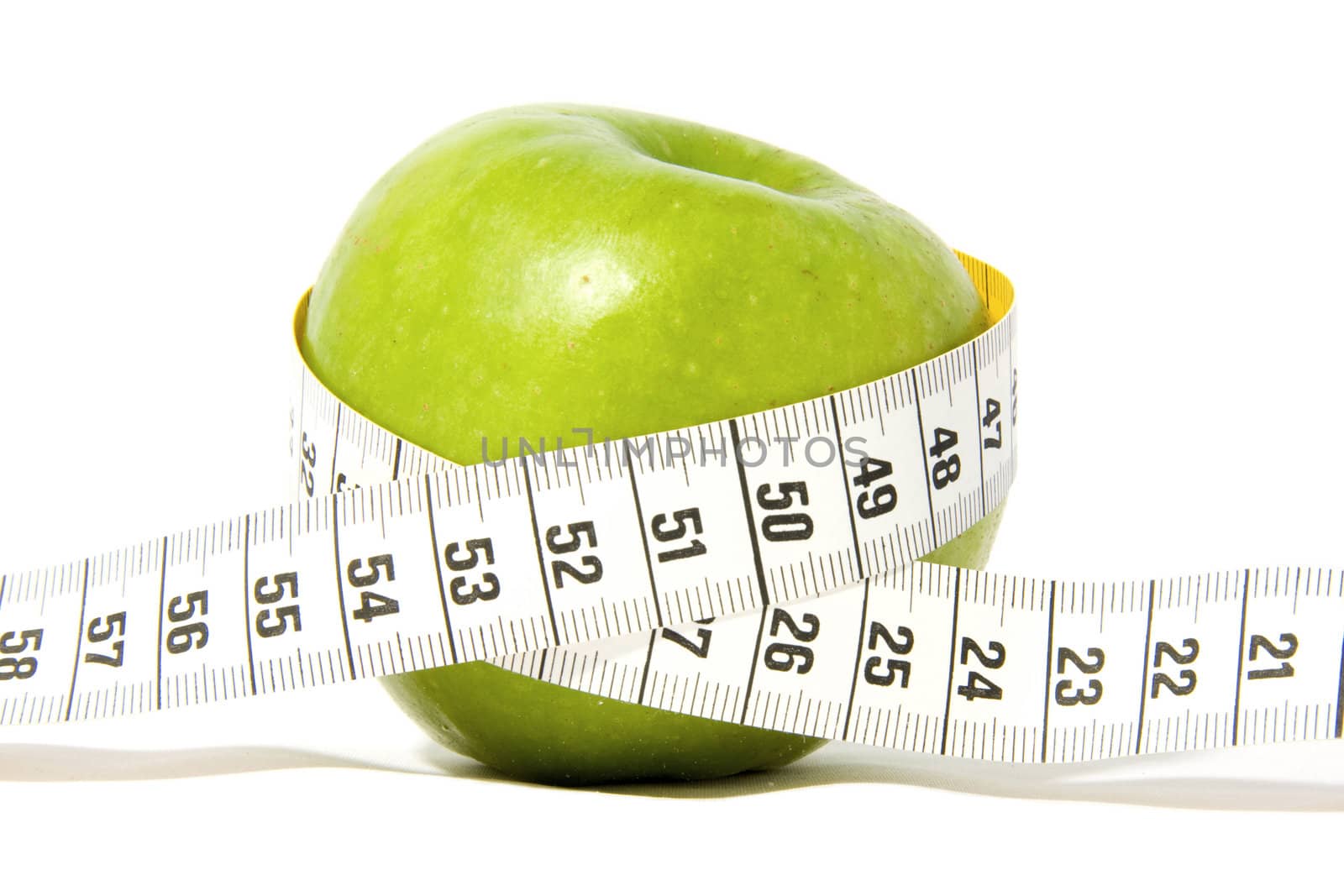 Green apple with measure-tape isolated on white background