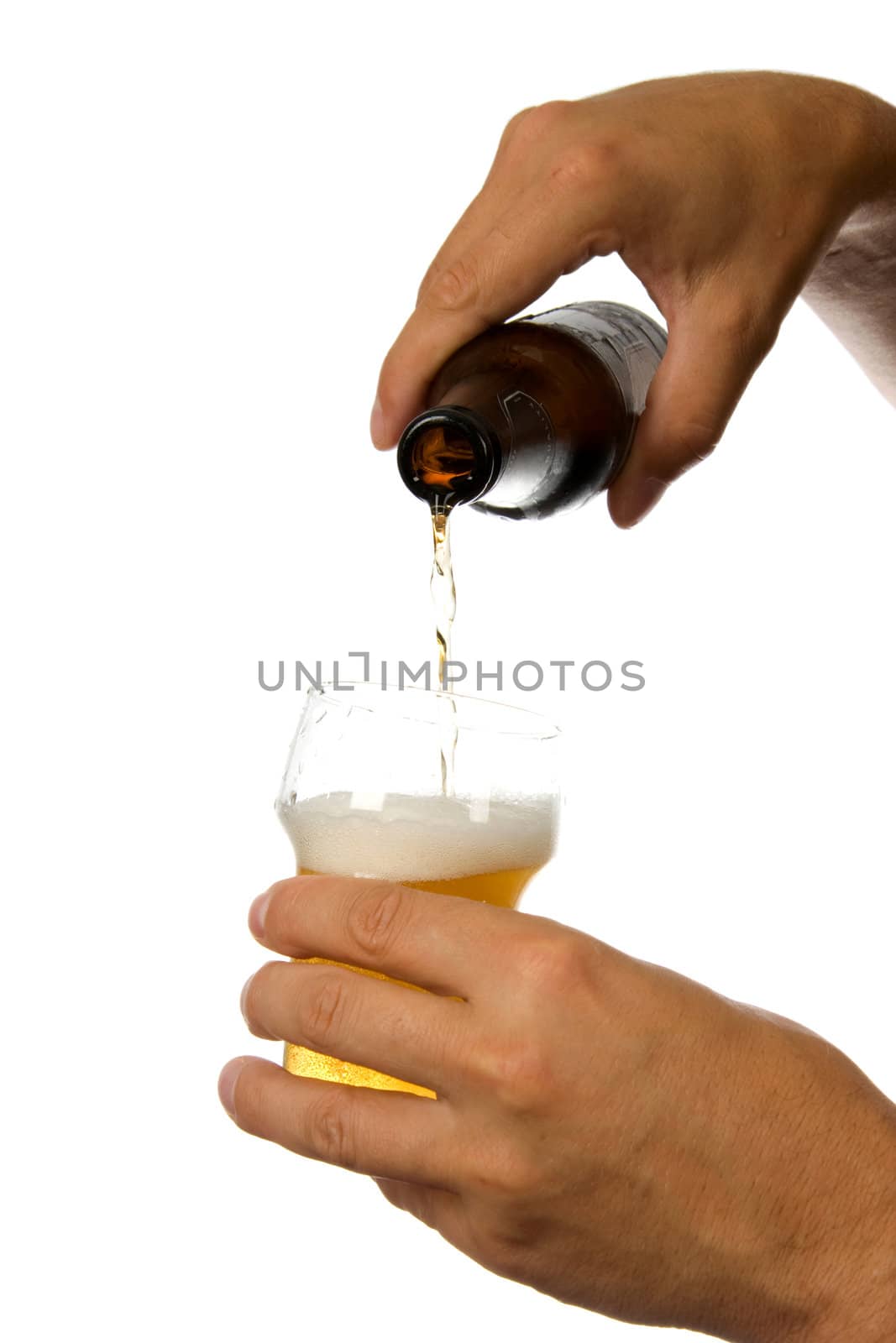 Man is pouring beer into glass isolated on white background