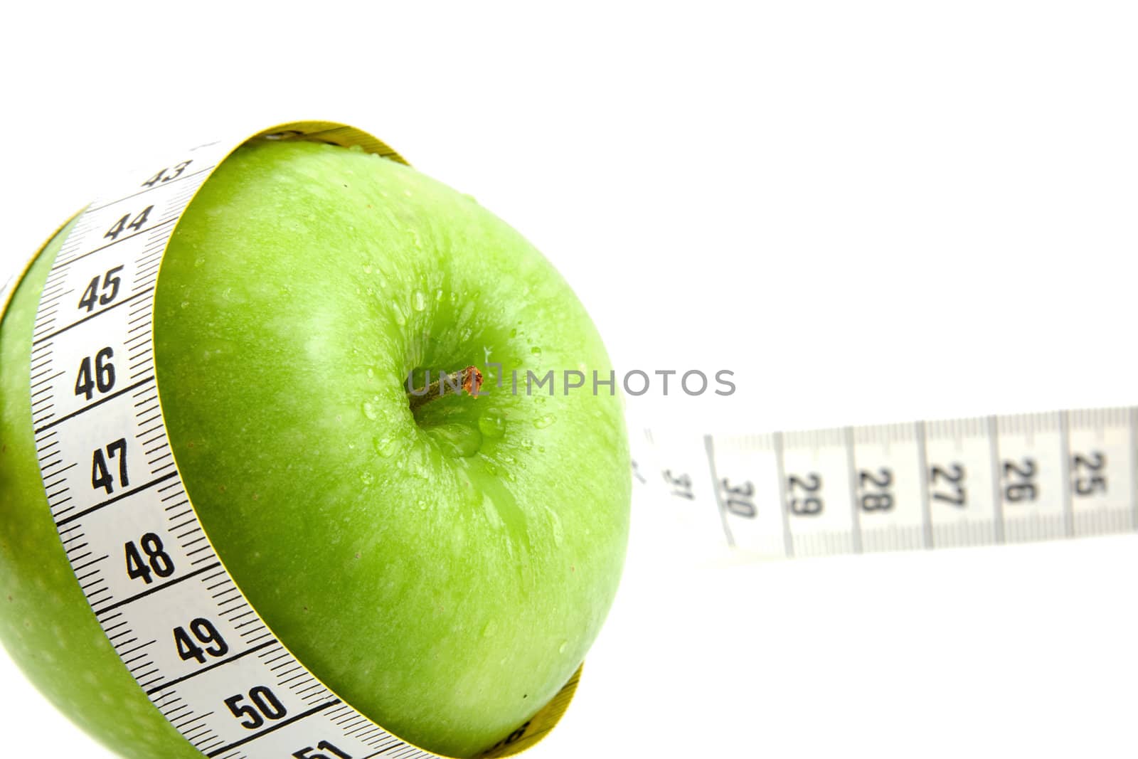 Fresh green apple with measure tape isolated on white background