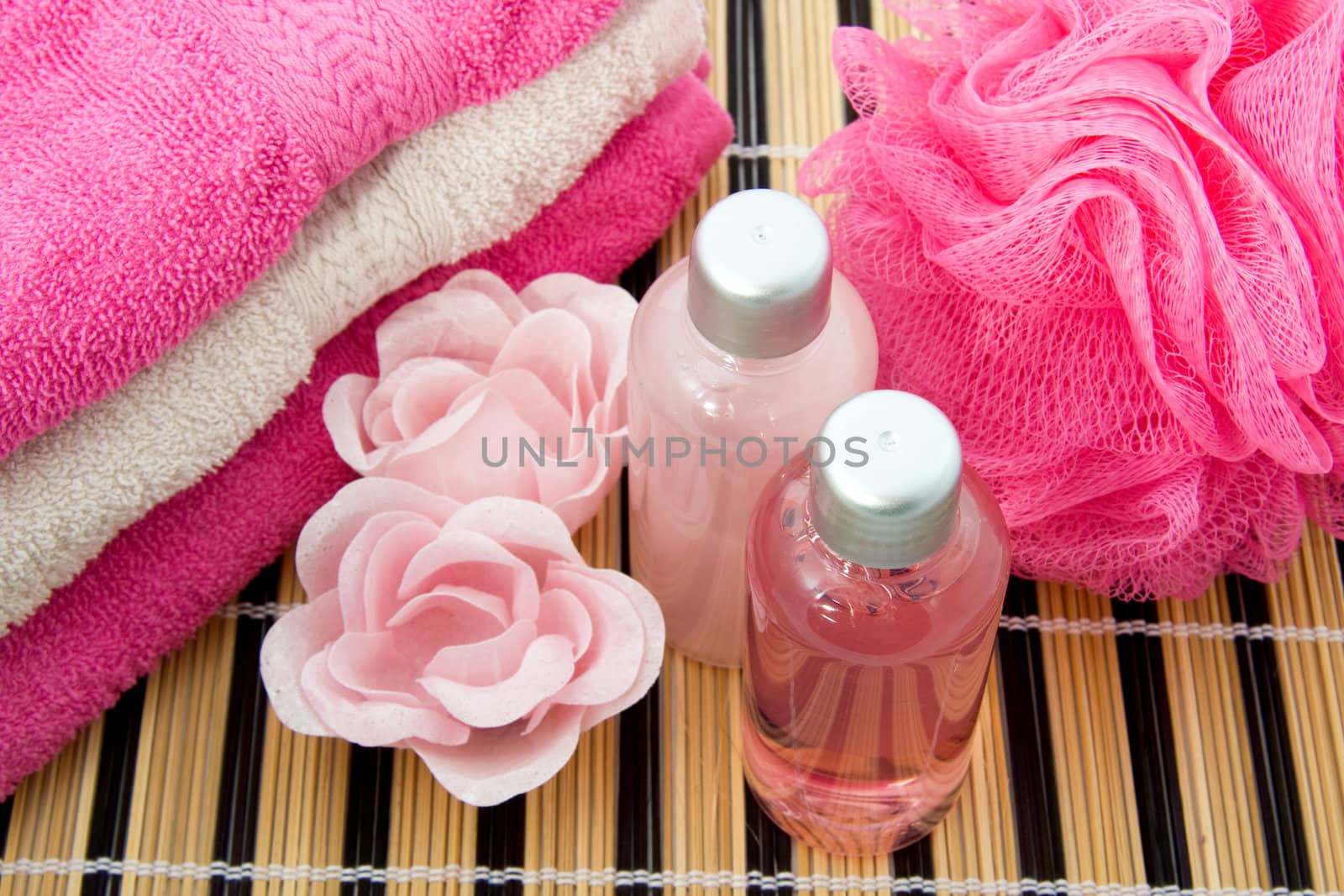 Pink colored bath accessory over white background