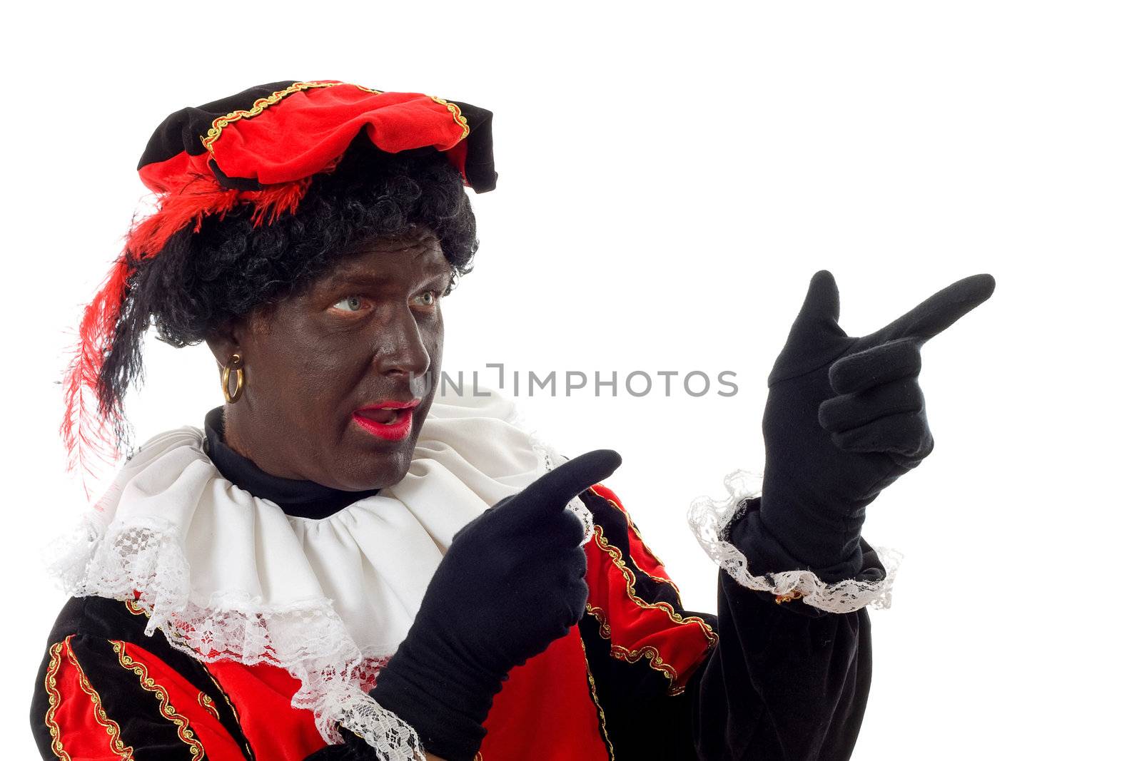 Zwarte piet ( black pete) typical Dutch character part of a traditional event celebrating the birthday of  Sinterklaas in december over white background pointing