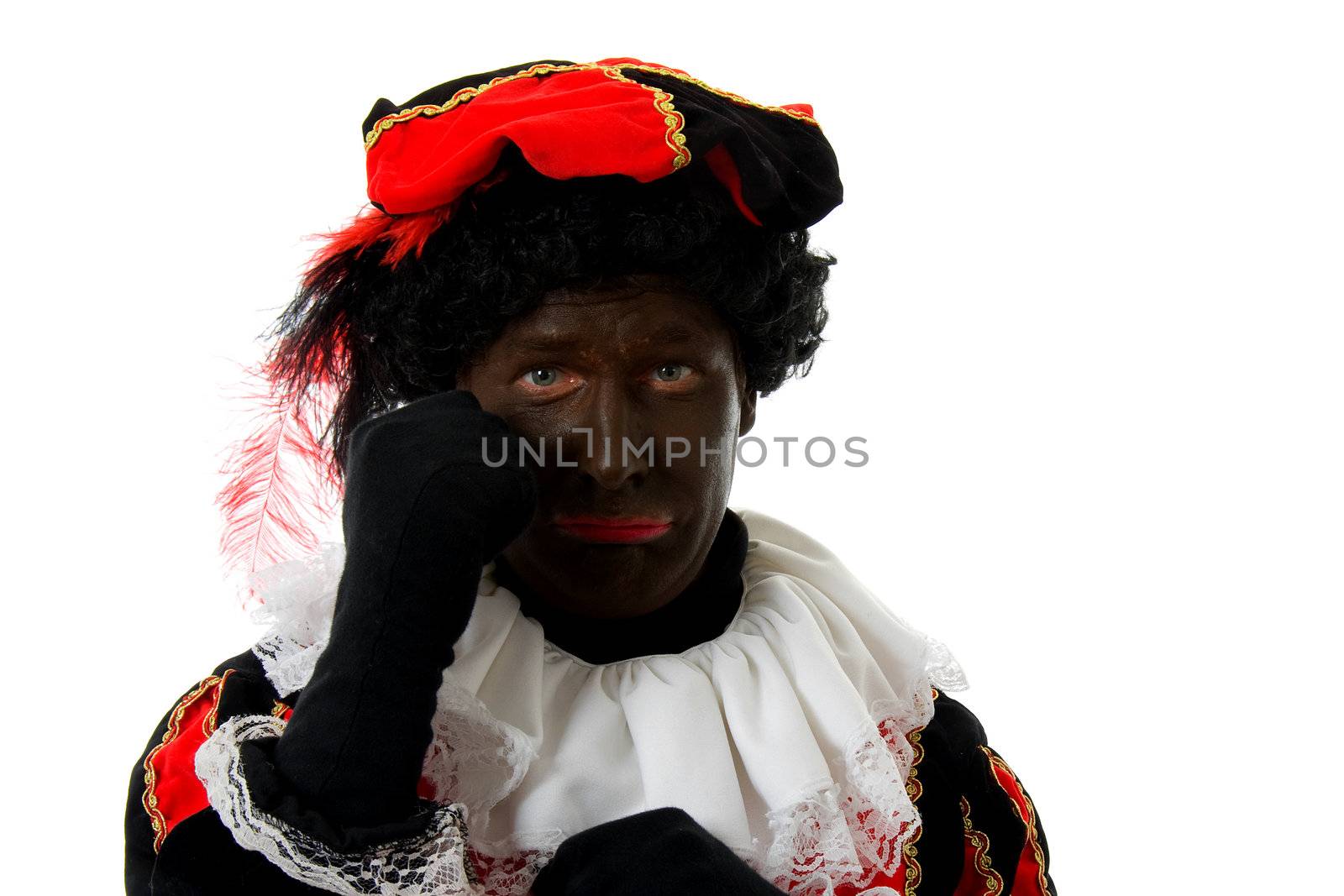 sad Zwarte piet ( black pete) typical Dutch character part of a traditional event celebrating the birthday of  Sinterklaas in december over white background