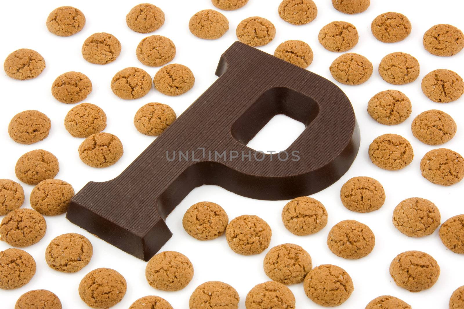 Chocolate letter P and ginger nuts for Sinterklaas, event in the Dutch in december, over white background
