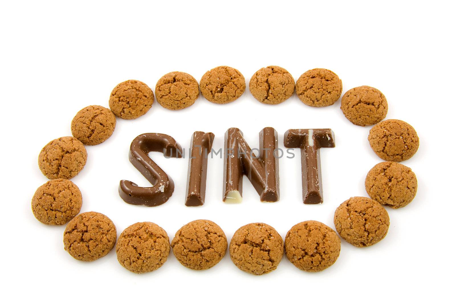 The word "Sint" in chocolate letters with circle of ginger nuts isolated on white background, typical Dutch candy for Sinterklaas event in december