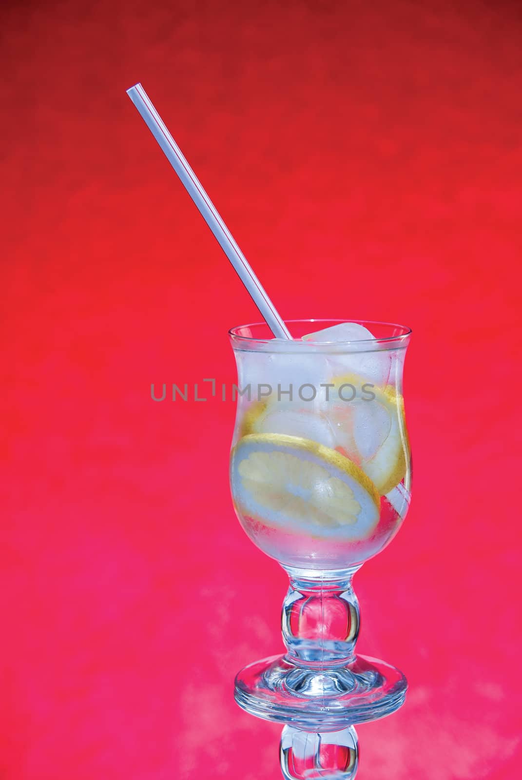 cold fresh with ice lemonade  on  red background