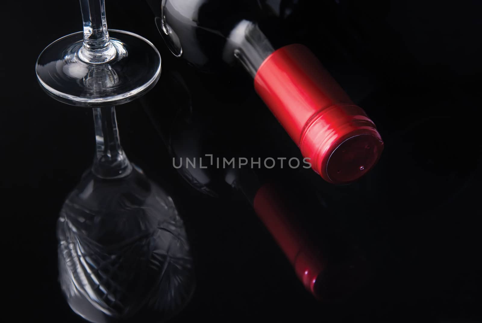 bottle of wine and a glass on a black background by Zhukow