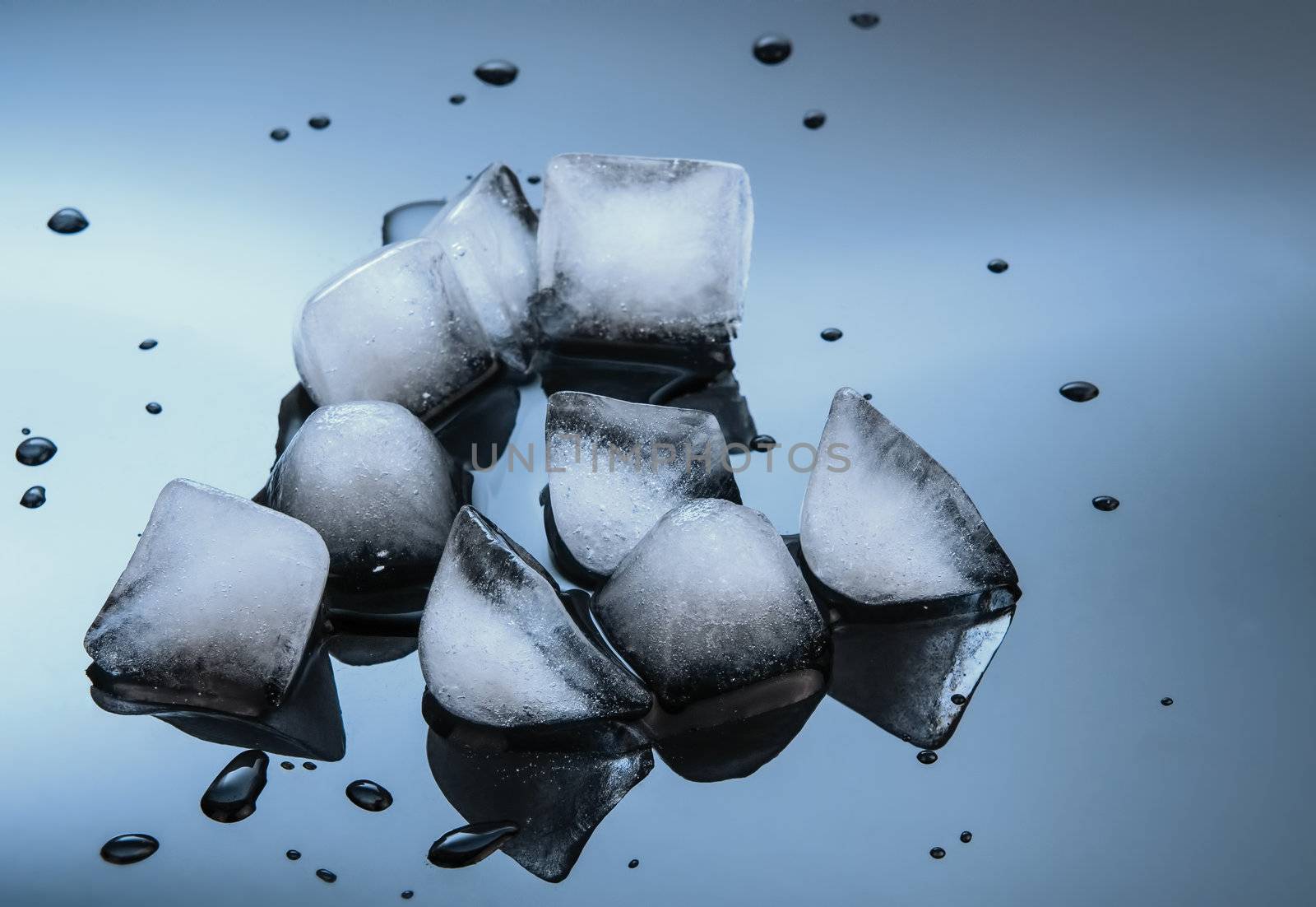 wet ice cubes on black glossy mirror background