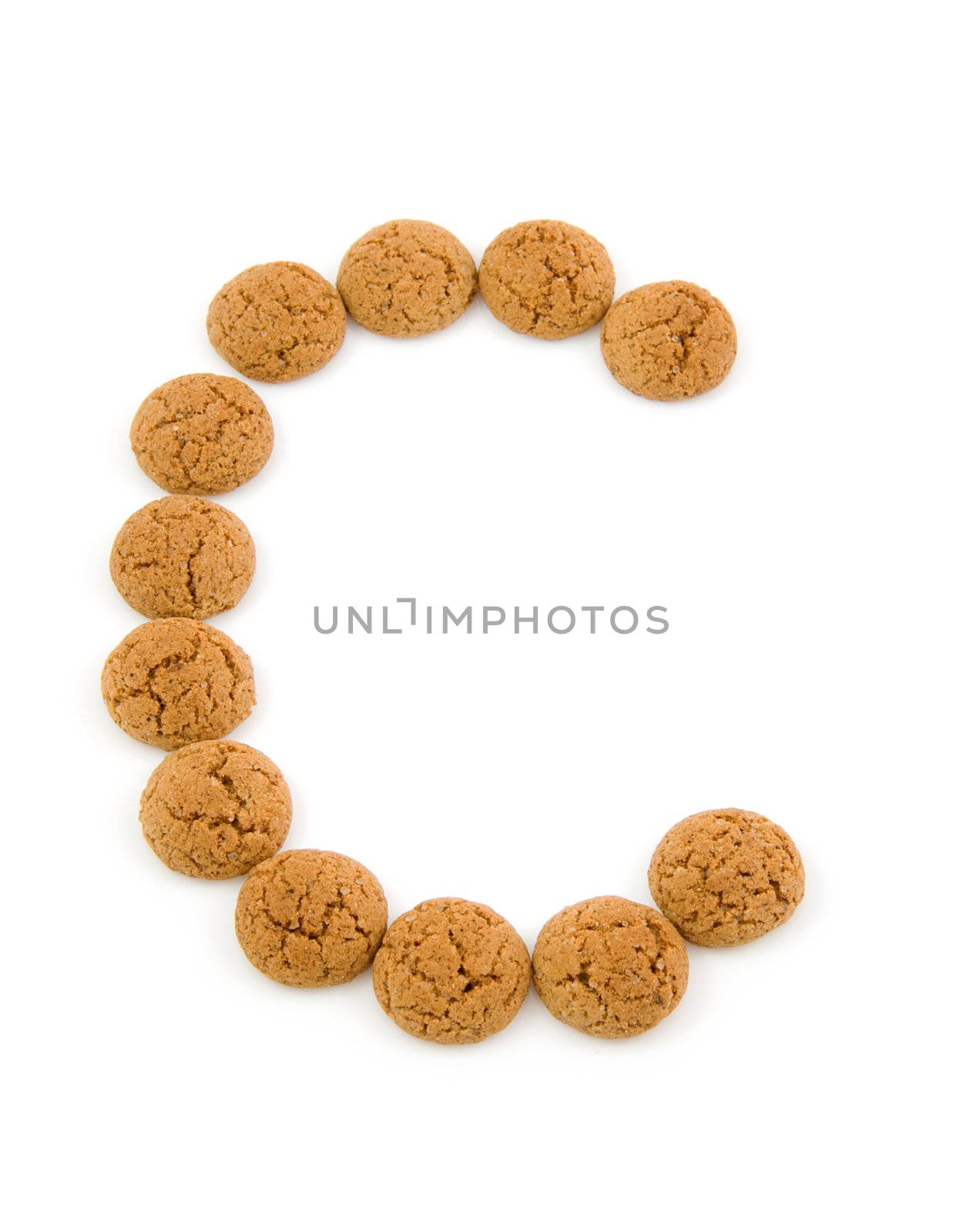 Ginger nuts, pepernoten, in the shape of letter C isolated on white background. Typical Dutch candy for Sinterklaas event in december.