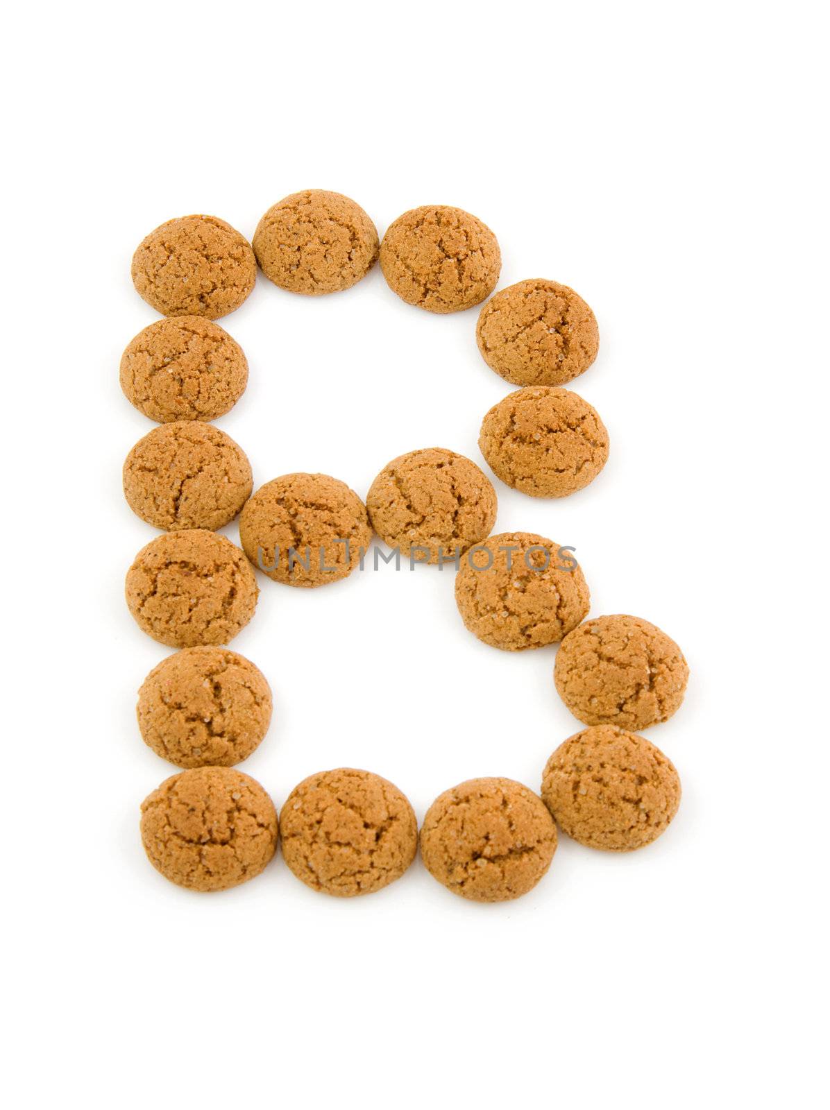 Ginger nuts, pepernoten, in the shape of letter B isolated on white background. Typical Dutch candy for Sinterklaas event in december.