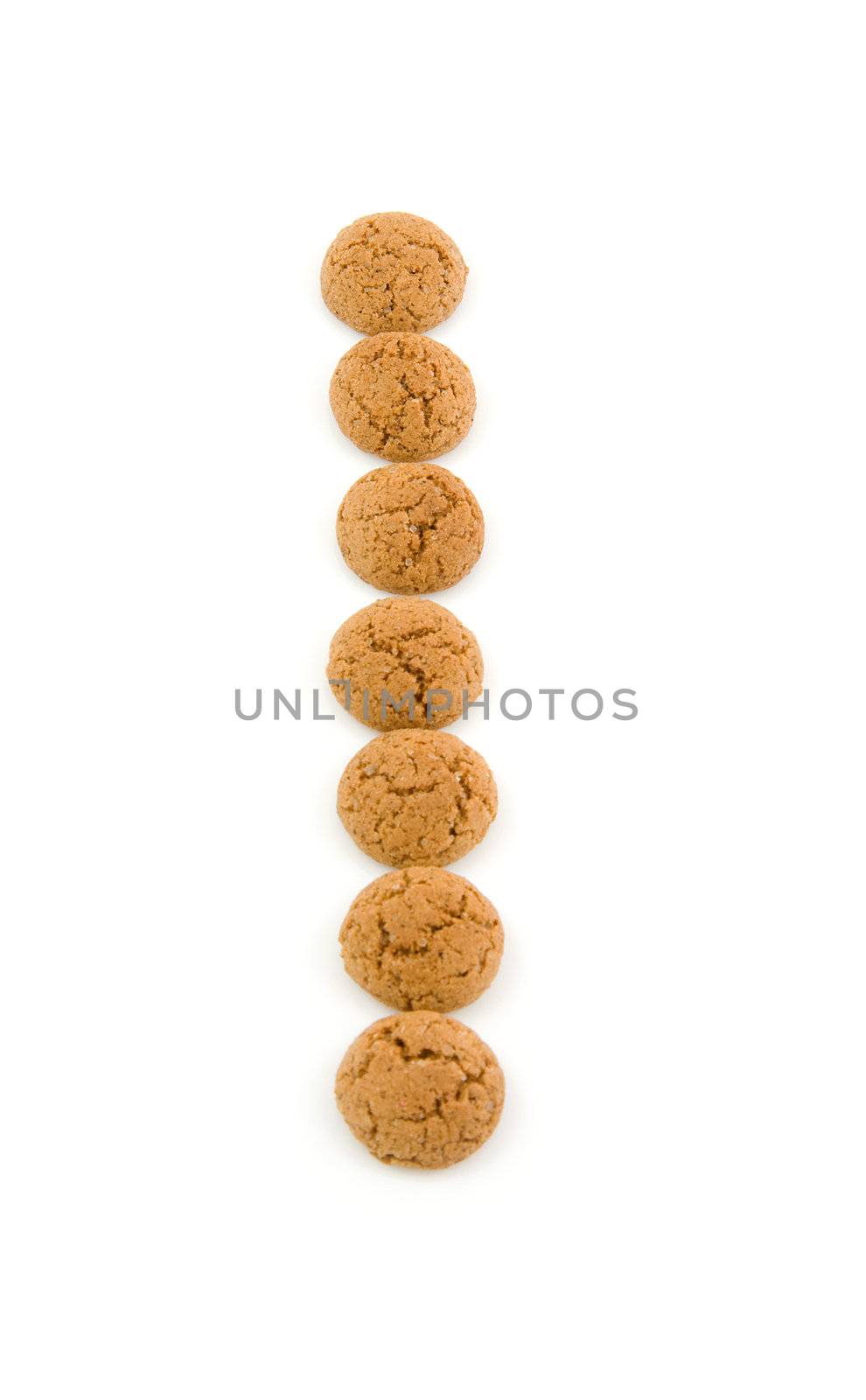 Ginger nuts, pepernoten, in the shape of letter "I" isolated on white background. Typical Dutch candy for Sinterklaas event in december.