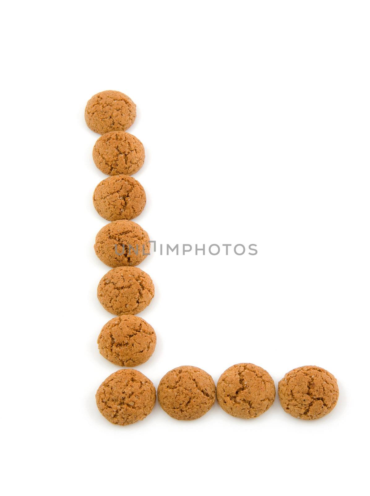 Ginger nuts, pepernoten, in the shape of letter L isolated on white background. Typical Dutch candy for Sinterklaas event in december.
