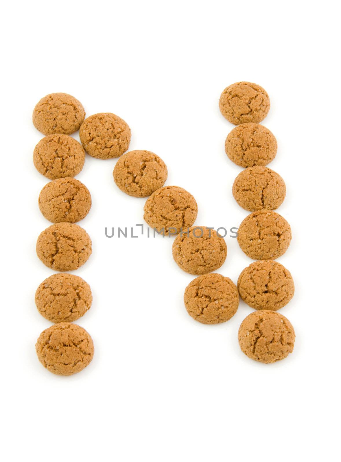 Ginger nuts, pepernoten, in the shape of letter N isolated on white background. Typical Dutch candy for Sinterklaas event in december.