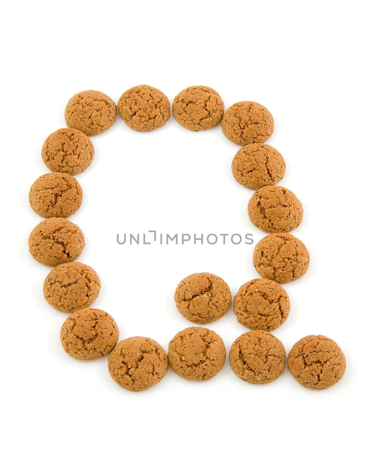 Ginger nuts, pepernoten, in the shape of letter Q isolated on white background. Typical Dutch candy for Sinterklaas event in december.