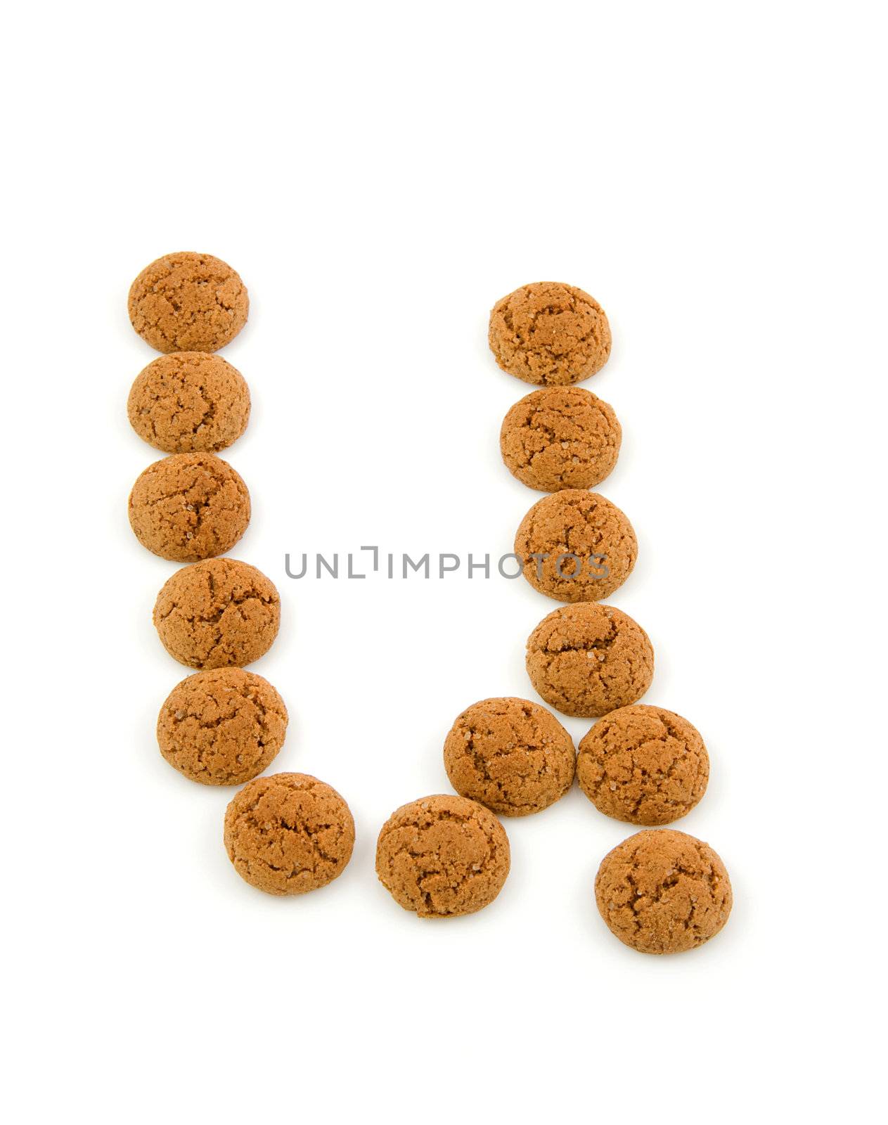 Ginger nuts, pepernoten, in the shape of letter U isolated on white background. Typical Dutch candy for Sinterklaas event in december.