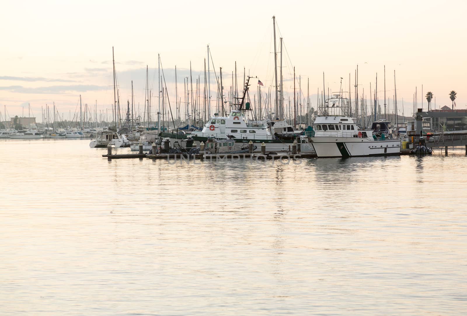 Boats and yachts in harbor at Ventura at dawn as sun is rising