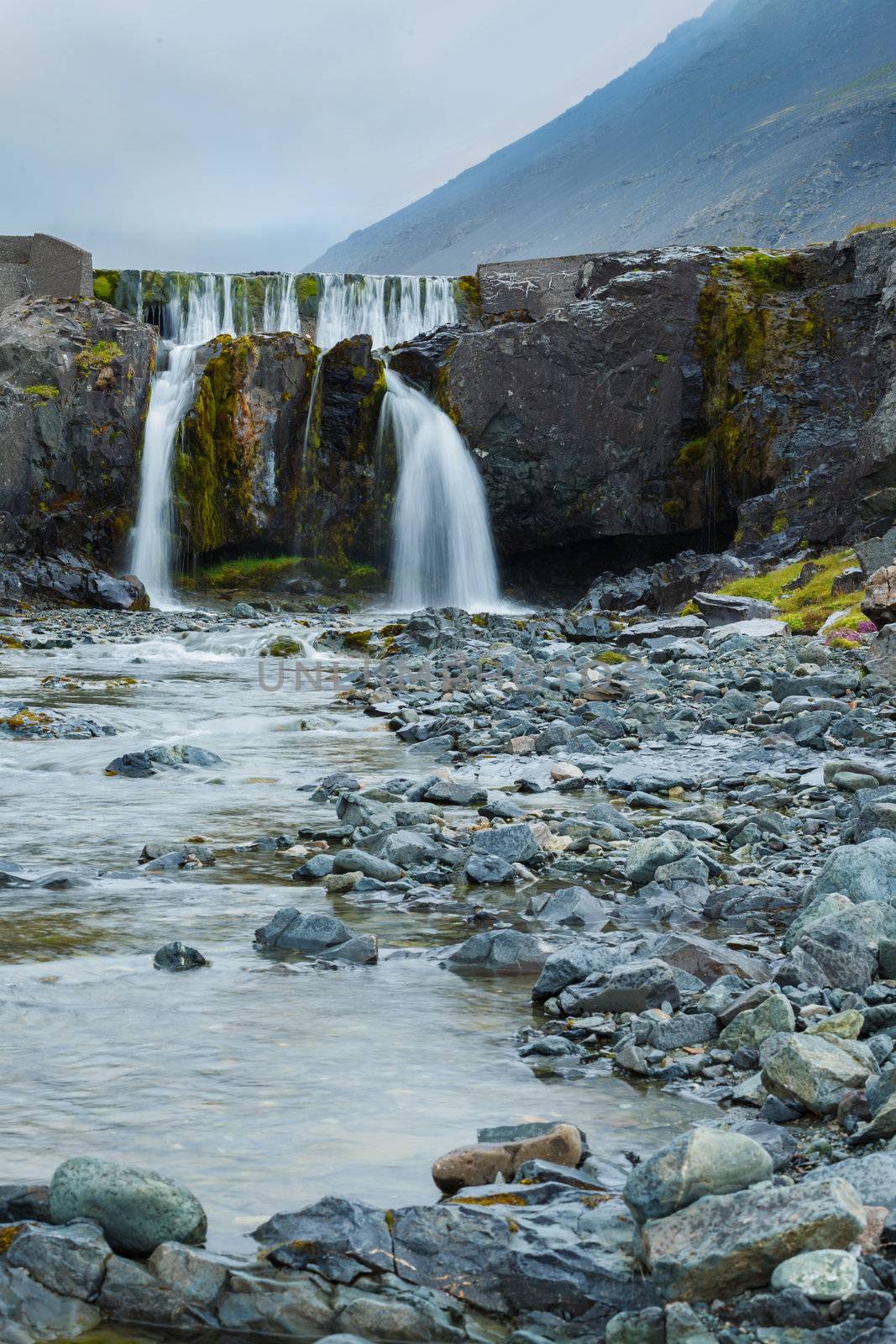 Waterfall in Iceland, landscape with beautiful nature. Vertical view