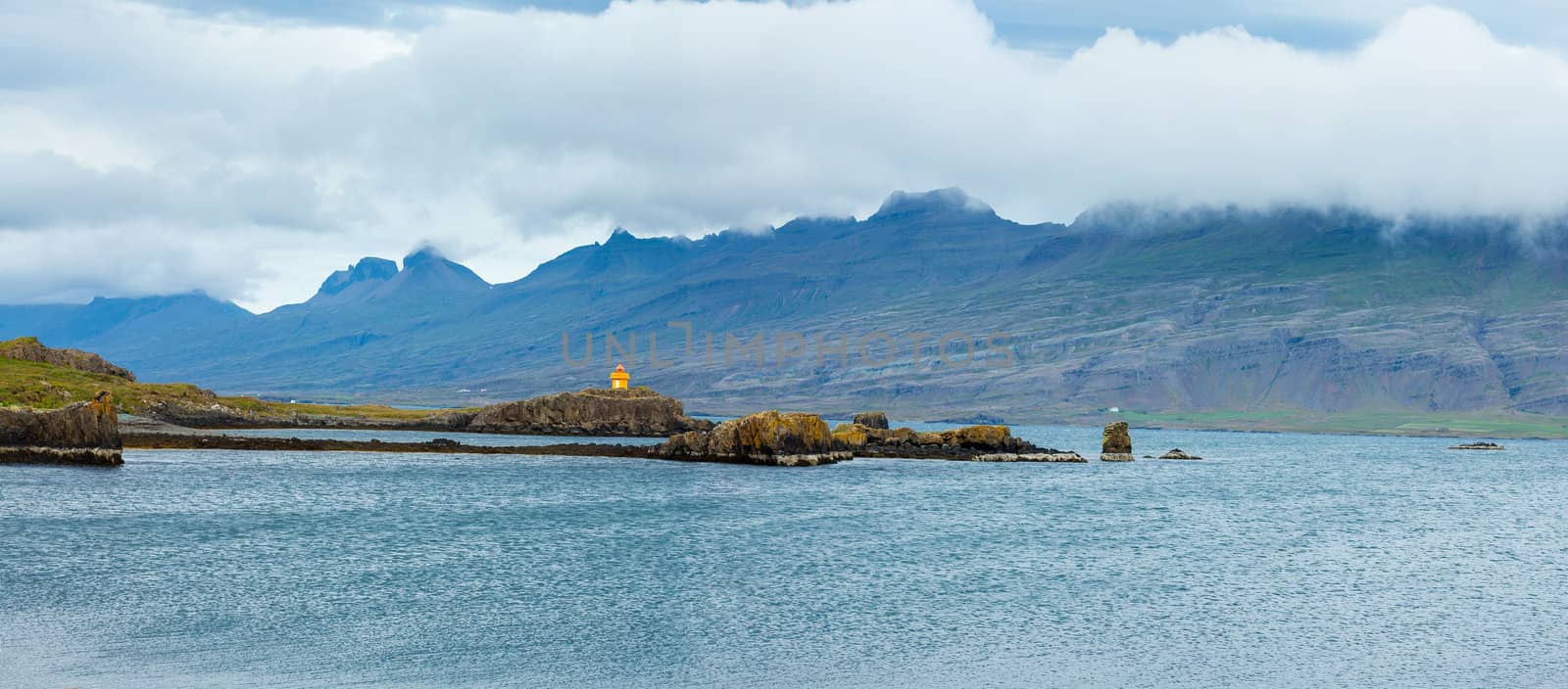North Iceland Sea Landscape with Orange Lighthouse and clouds Sky. Panorama