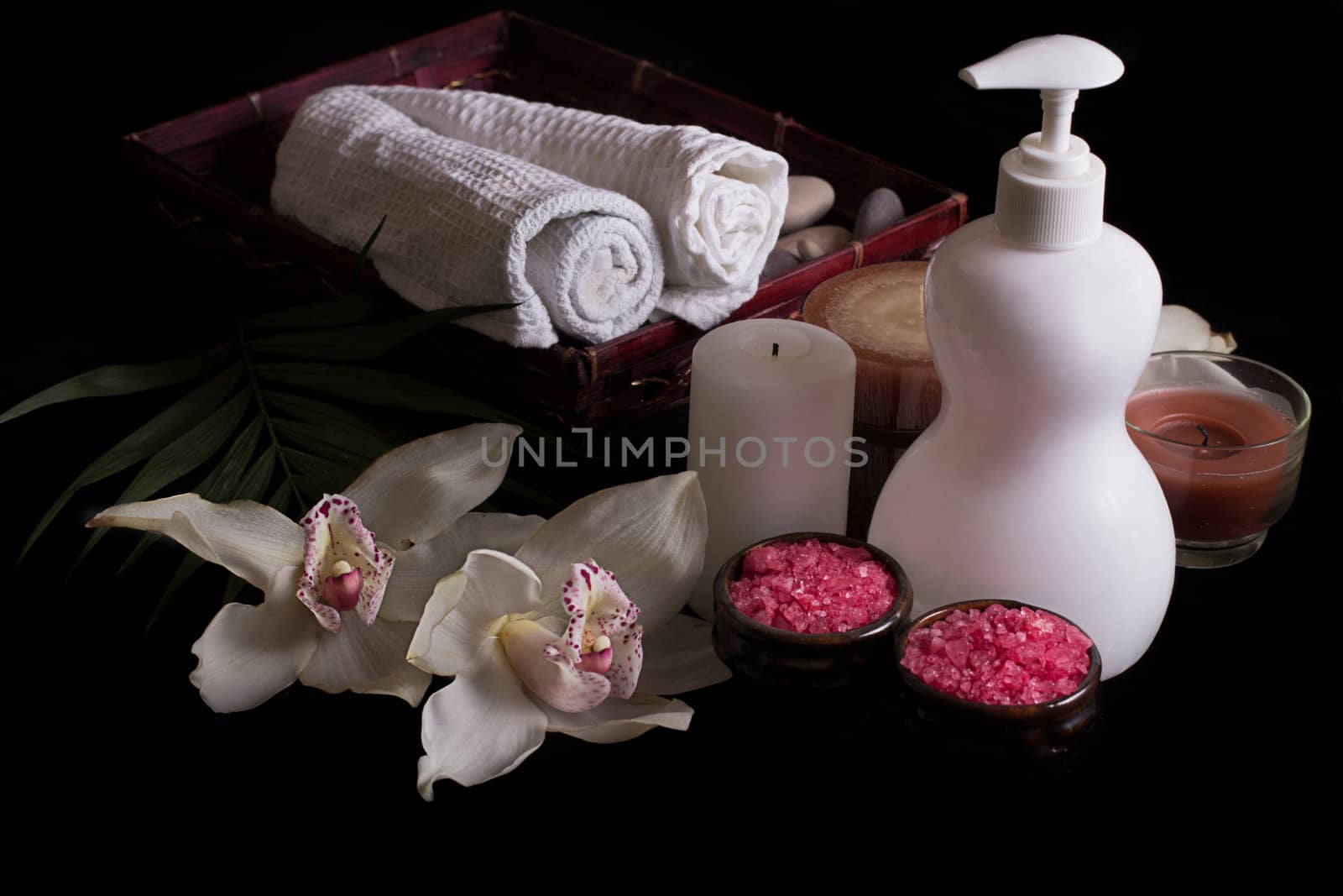 White orchids, spa treatment in wooden box isolated on black